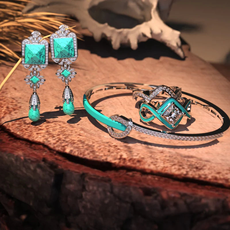 Image of a bundle of turquoise jewelry featuring a pair of turquoise earrings, a turquoise bracelet and the best selling turquoise ring "The Ocean Wave" from Awareness Avenue