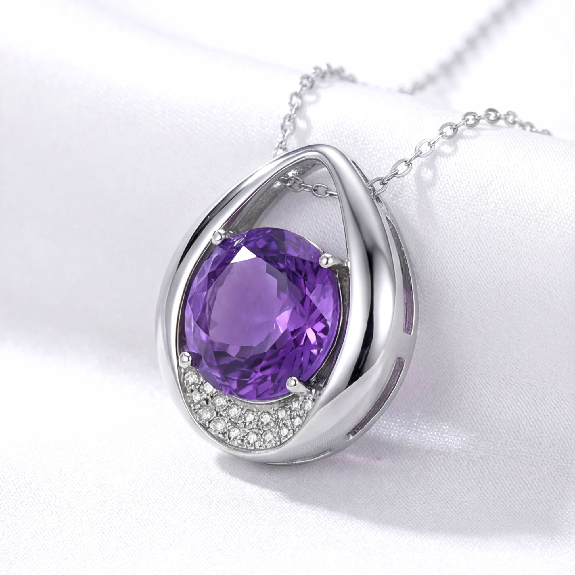Side view of the S925 sterling silver drop pendant with a round cut purple simulated amethyst on white fabric.