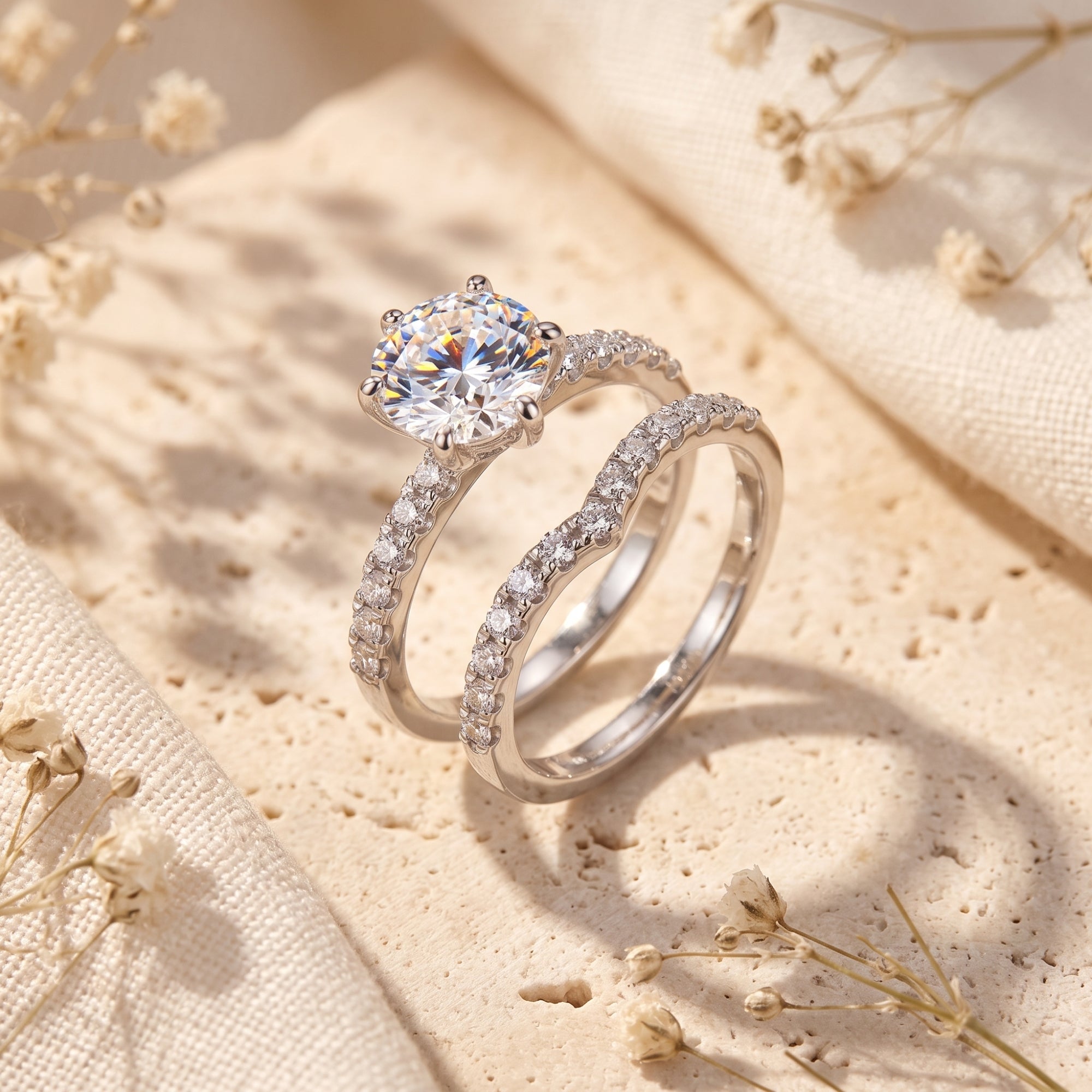 Amariel silver nesting ring set with round simulated diamond on stone with dried flowers.