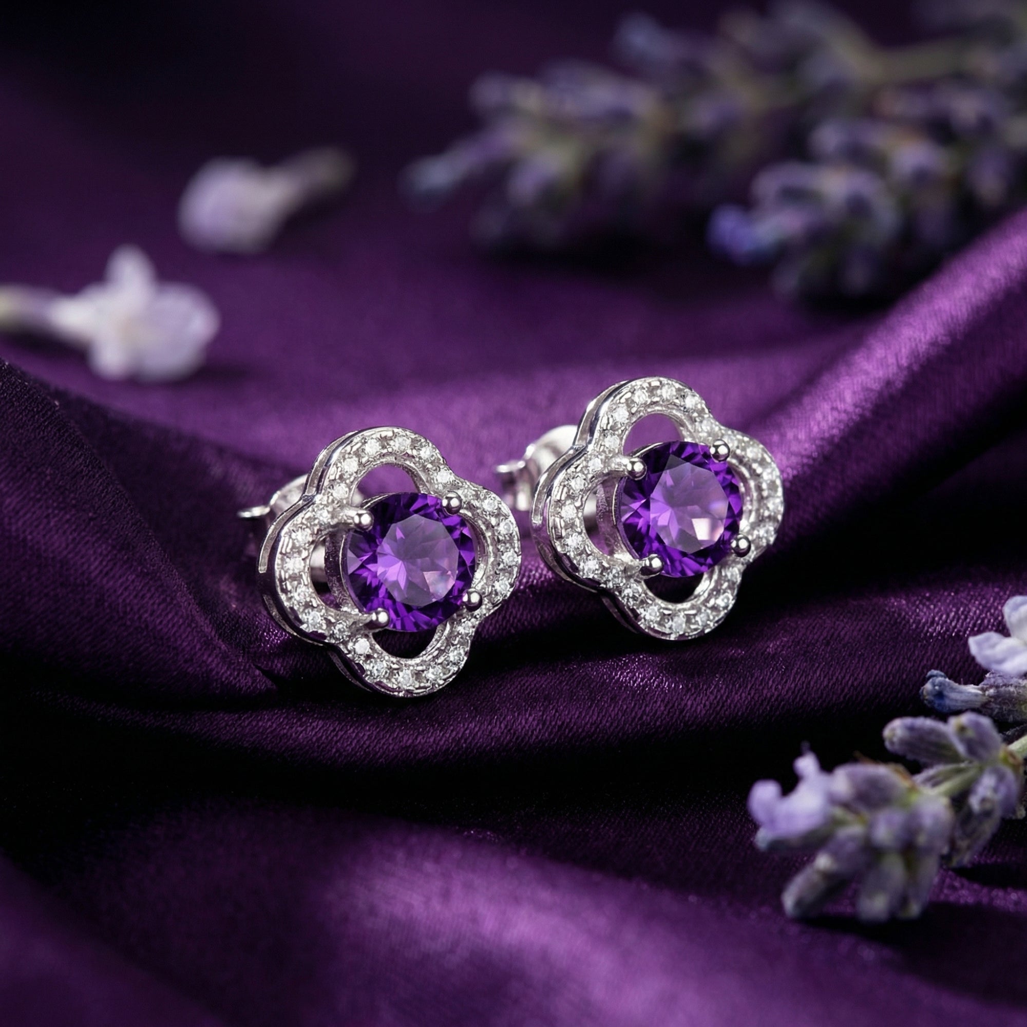 Round cut natural amethyst studs in S925 sterling silver quatrefoil settings on purple silk with lavender.