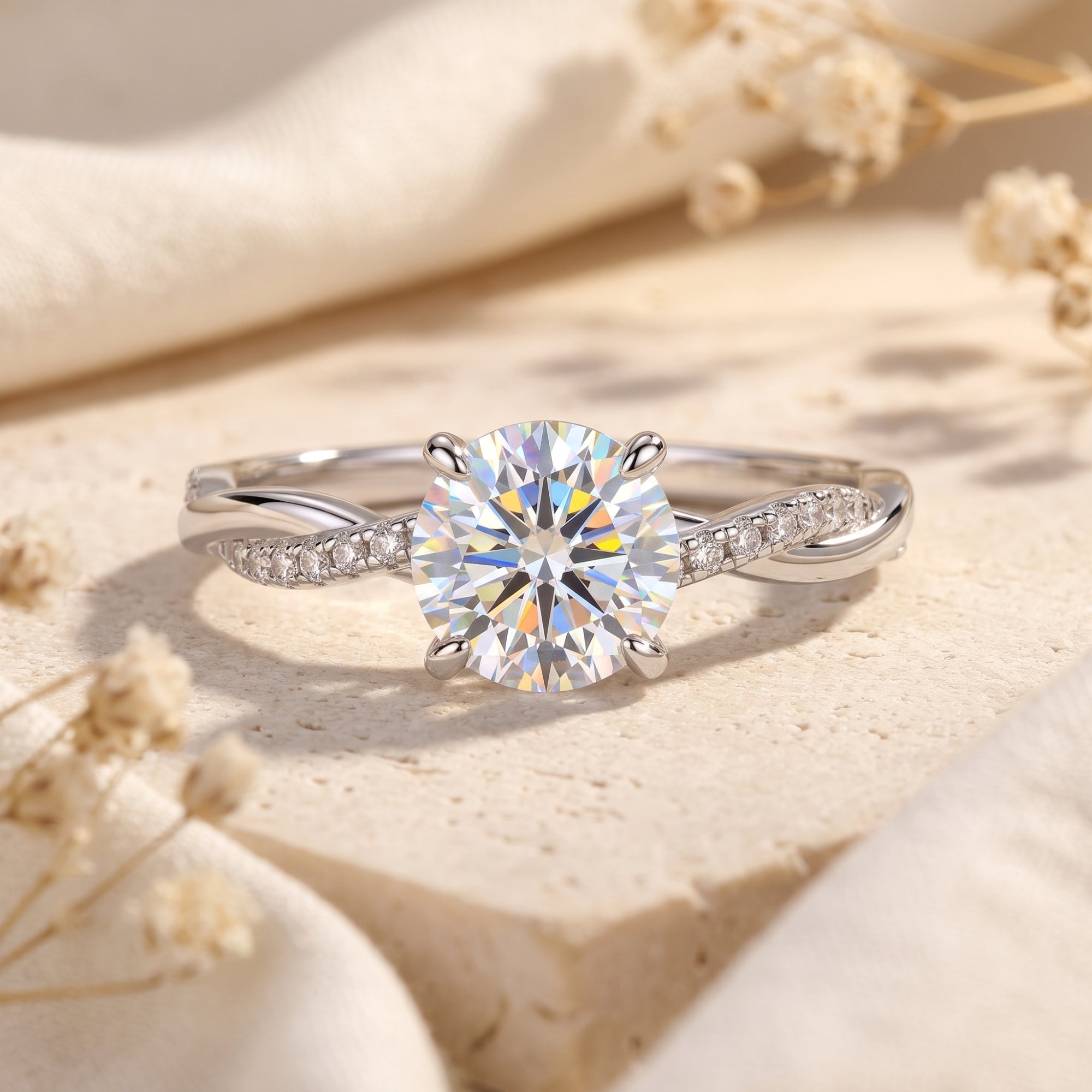 Round-cut simulated diamond solitaire ring in S925 sterling silver with a twisted pavé band on a stone surface.