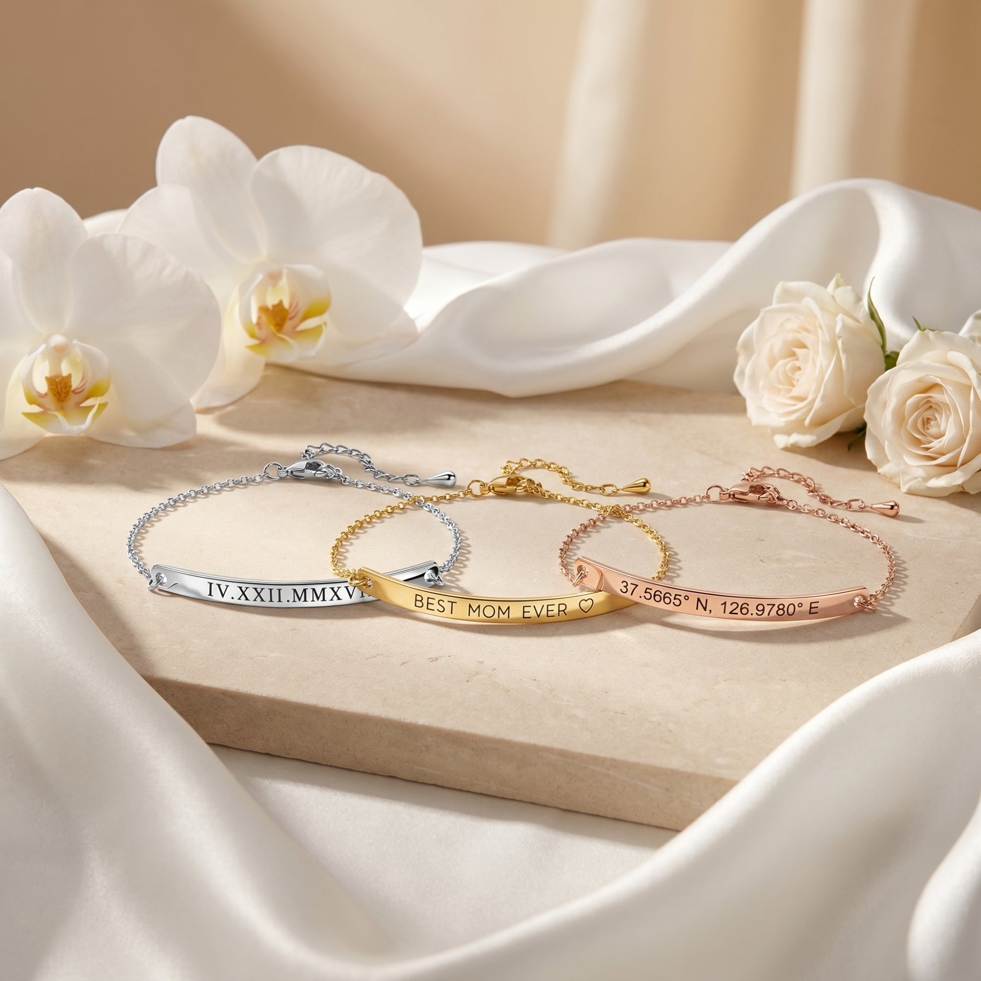 Silver, gold, and rose gold Eleanor Bar Bracelets with custom engravings on a styled lifestyle background with flowers.