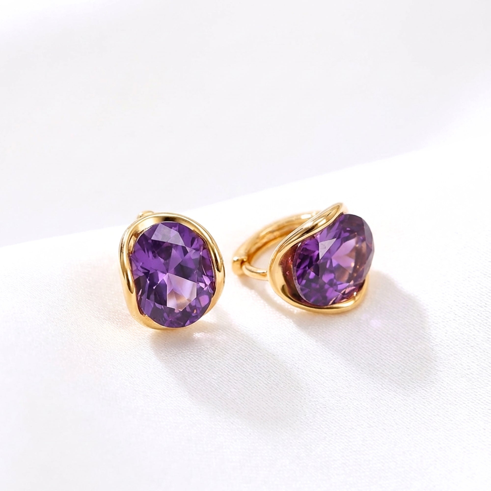 Oval cut simulated amethyst hoop earrings in 18K gold vermeil on a white studio background.