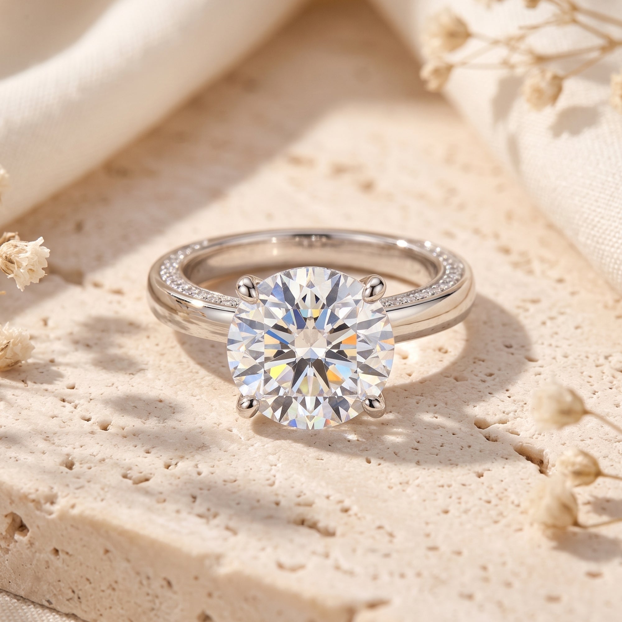 Round-cut simulated diamond solitaire ring in S925 sterling silver on a textured stone lifestyle background.