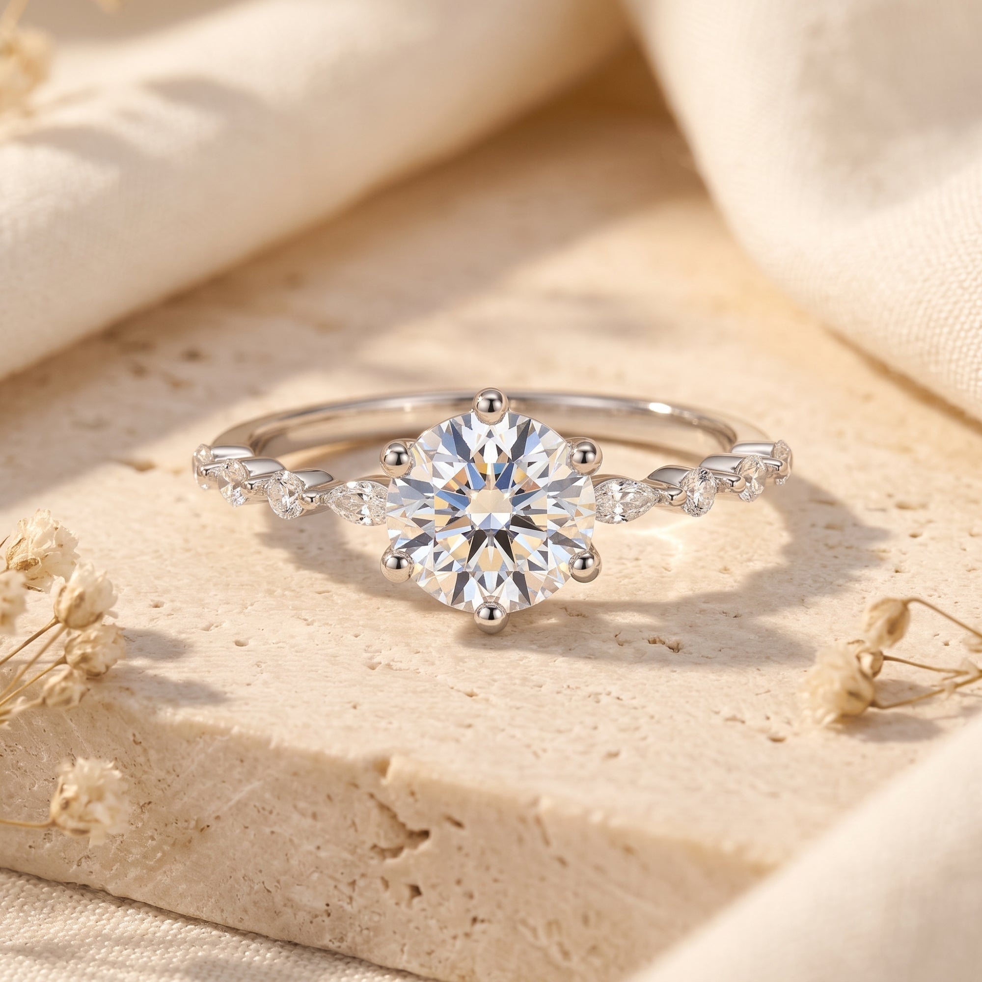 Belise sterling silver ring with round-cut simulated diamond on a stone surface with dried flowers.