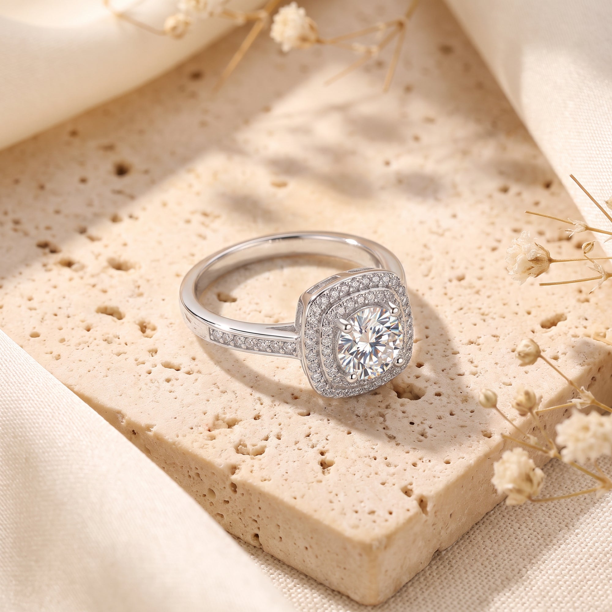 Sterling silver Juliette ring with round simulated diamond and square halo on textured stone.
