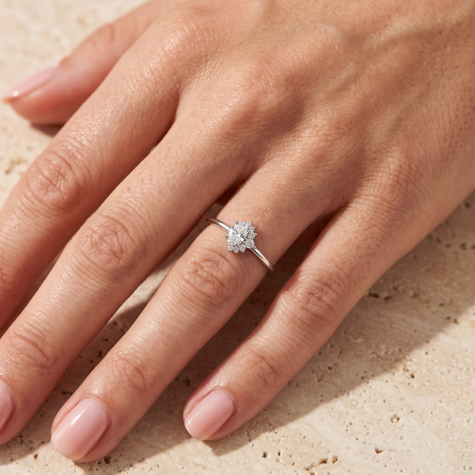 Sterling silver 2-carat oval moissanite ring worn on a woman's hand to show scale and fit.