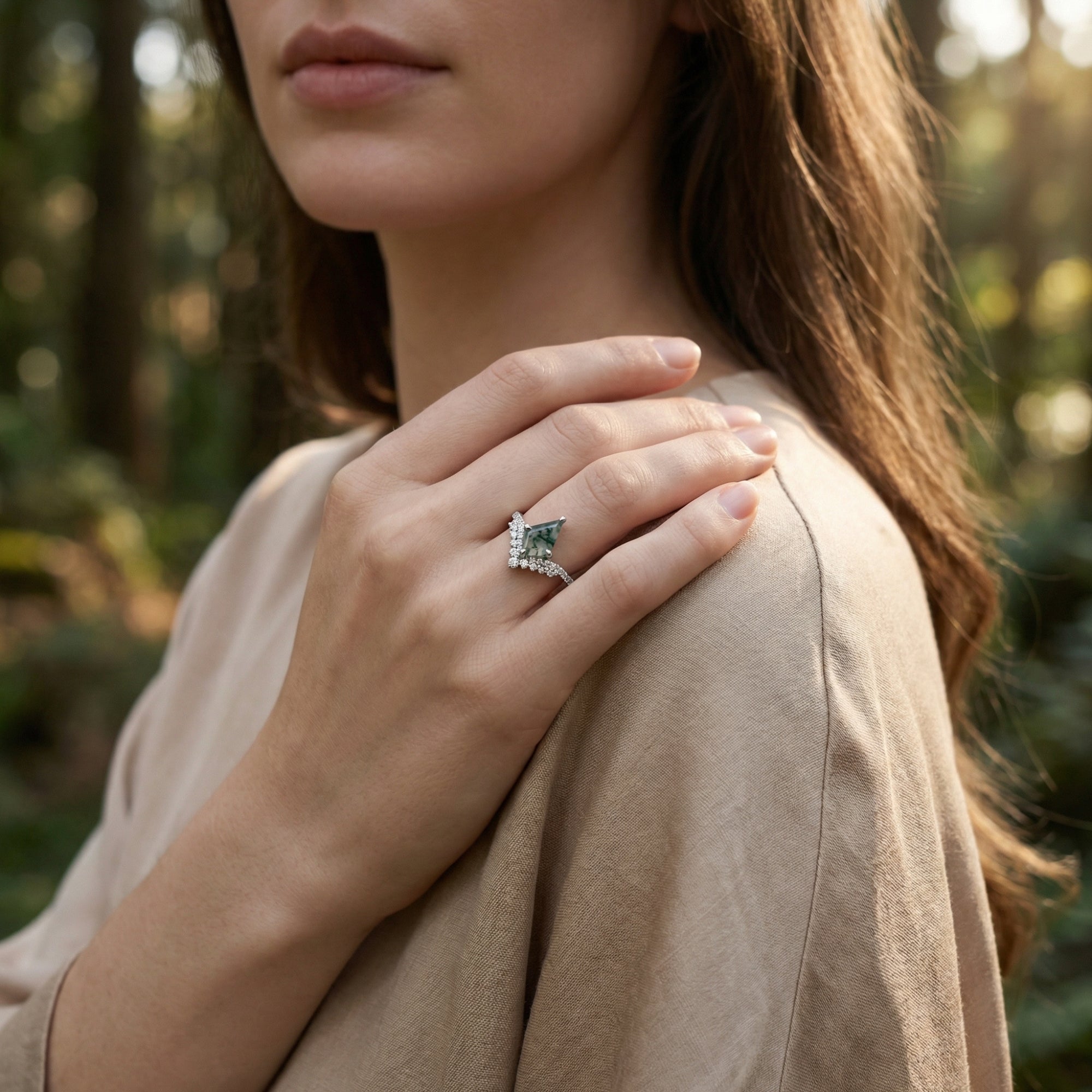 Model wearing the kite cut moss agate S925 sterling silver ring on her finger, hand resting on her shoulder.