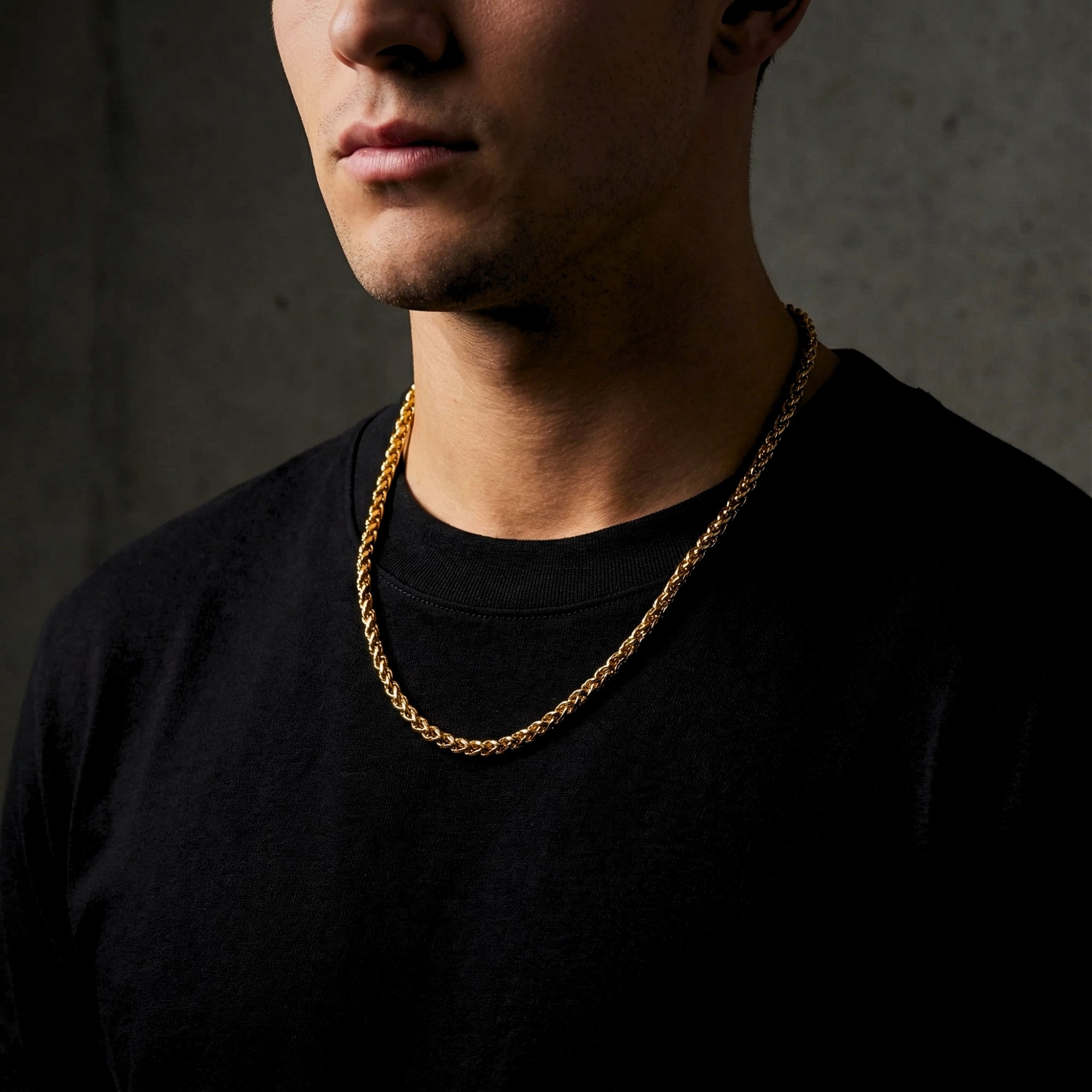Man wearing a 6mm gold stainless steel wheat chain over a black t-shirt.