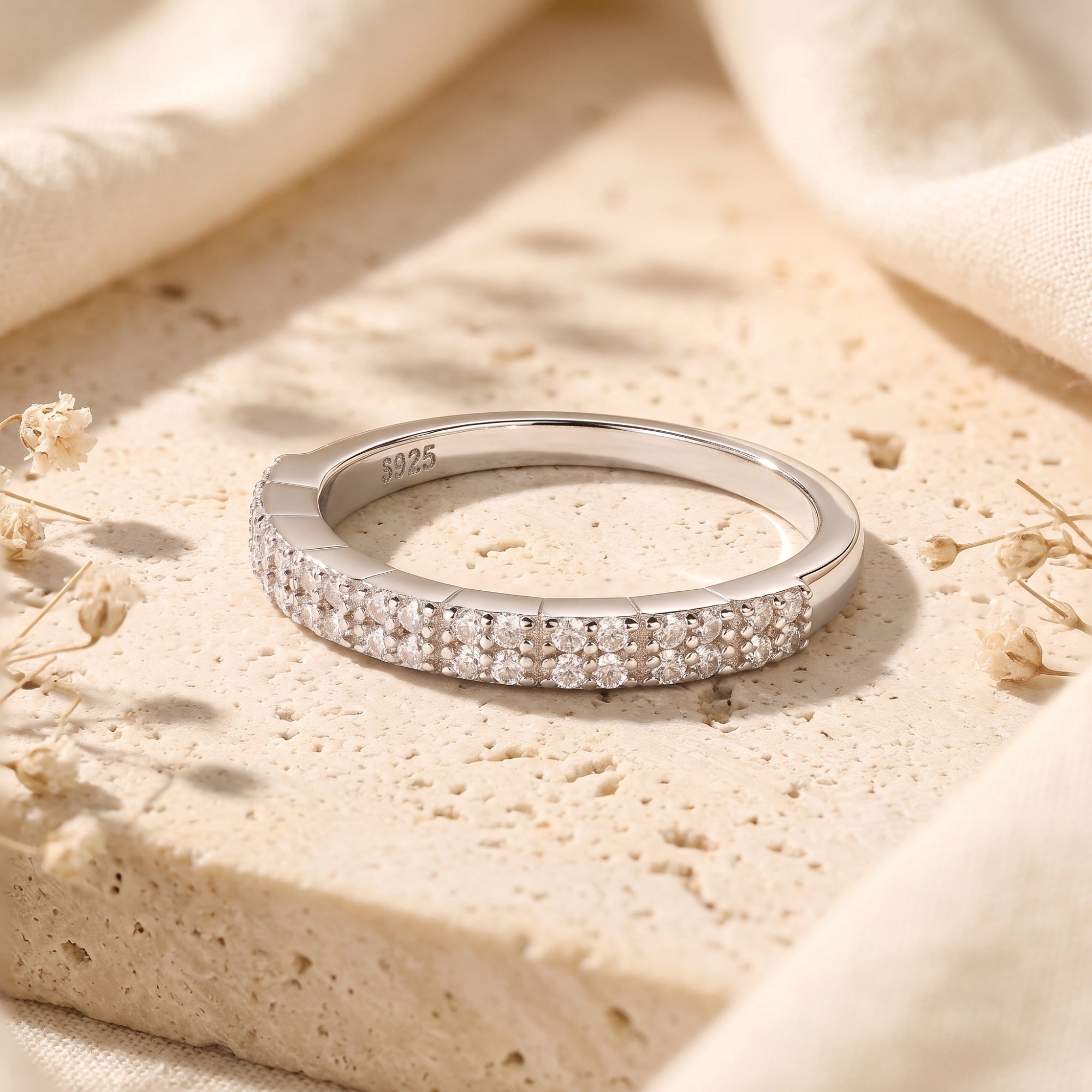 Macro view of the S925 hallmark and double row pavé setting on a silver ring.