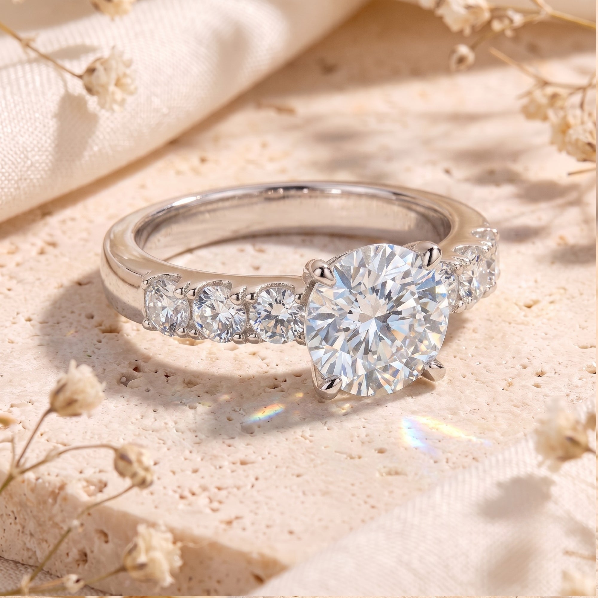 Macro view of a round cut simulated diamond ring with accented sterling silver band on stone.