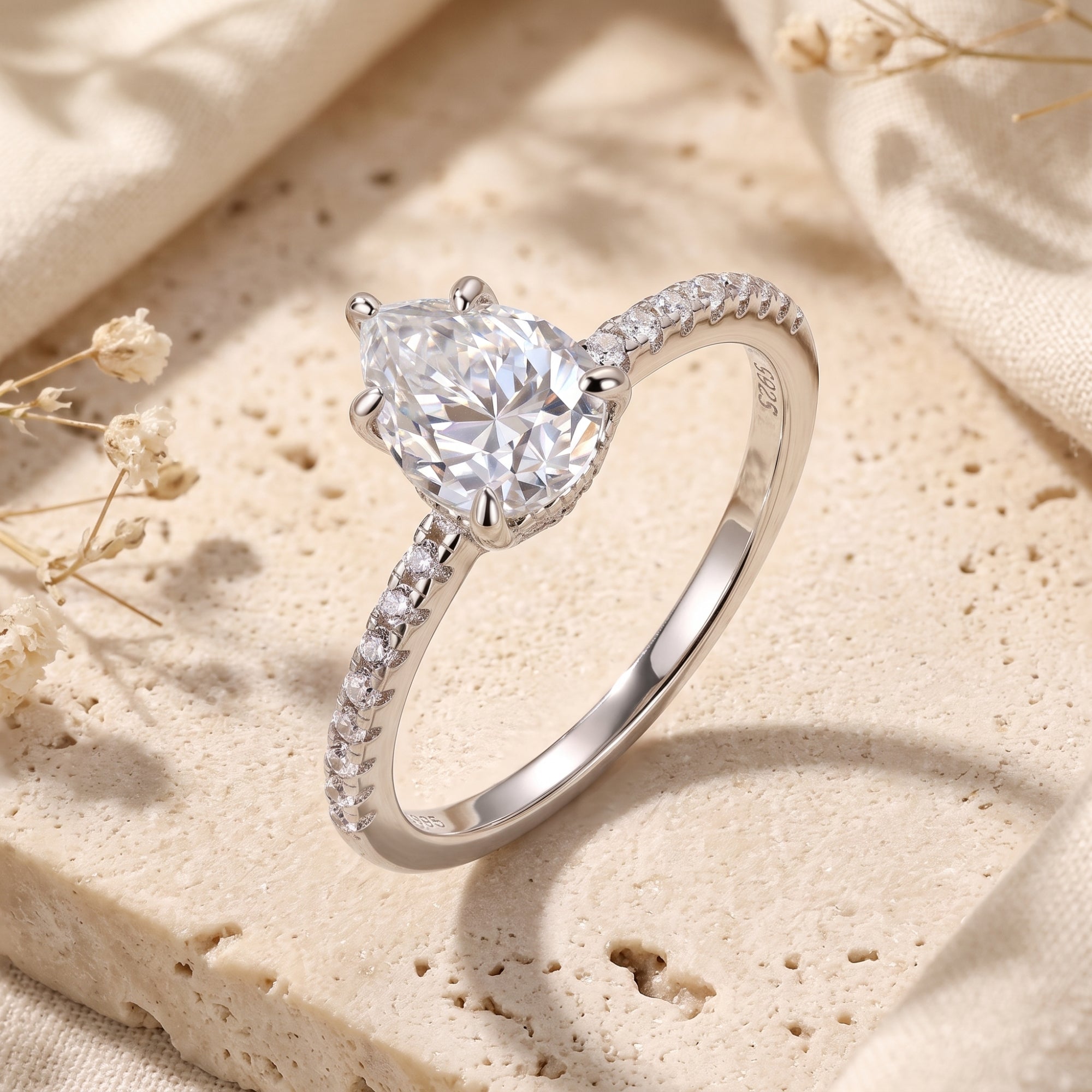 Side view of the Lunalise pear cut silver ring highlighting the S925 hallmark and pavé band.