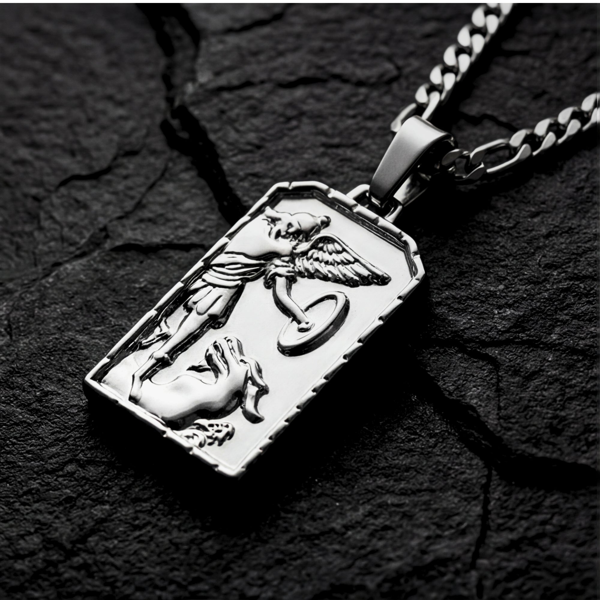Angled close-up of the silver St. Michael's Victory pendant, showing the detailed relief of the saint and dragon.
