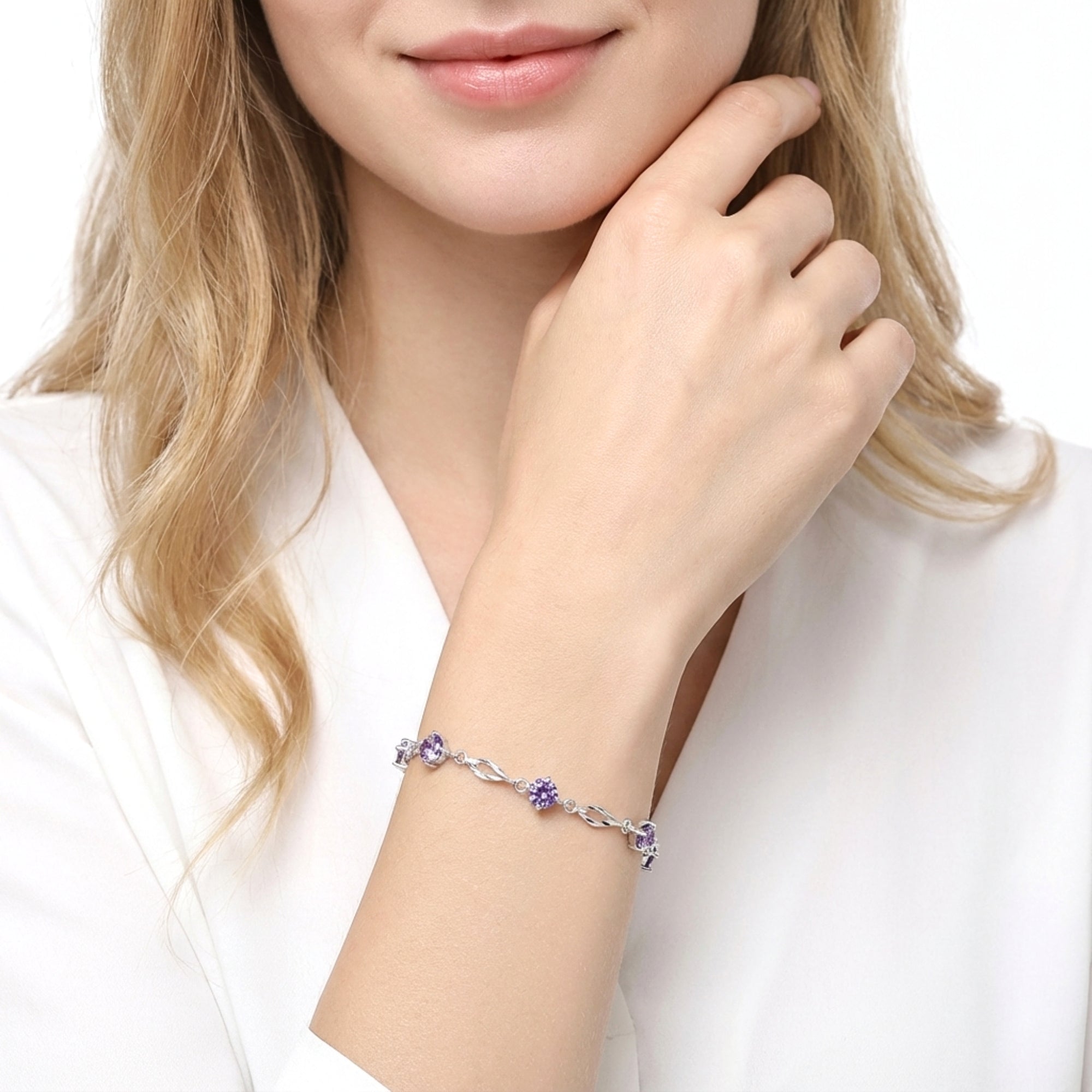 Model wearing the sterling silver Lyris station bracelet with purple simulated amethysts on her wrist.