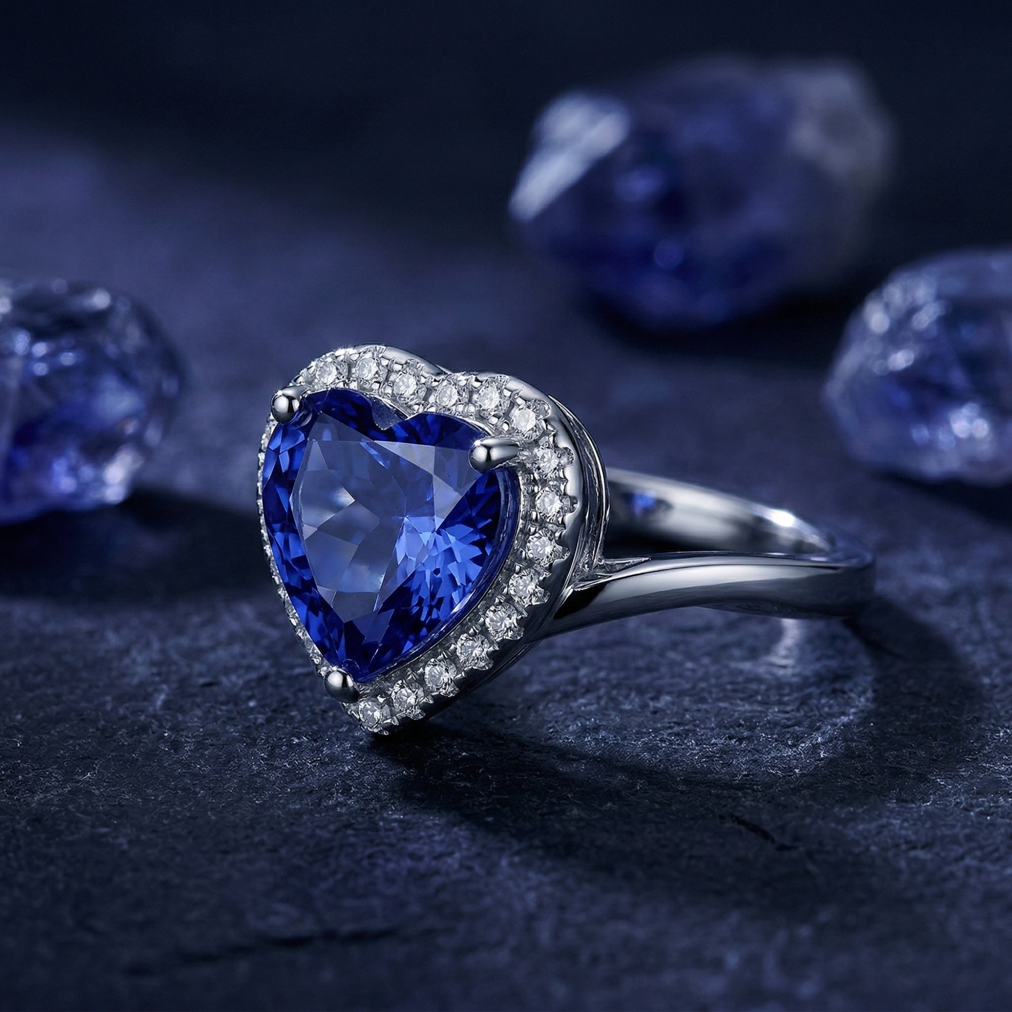 Macro view of the heart-cut tanzanite ring in sterling silver, highlighting the halo setting and side profile.