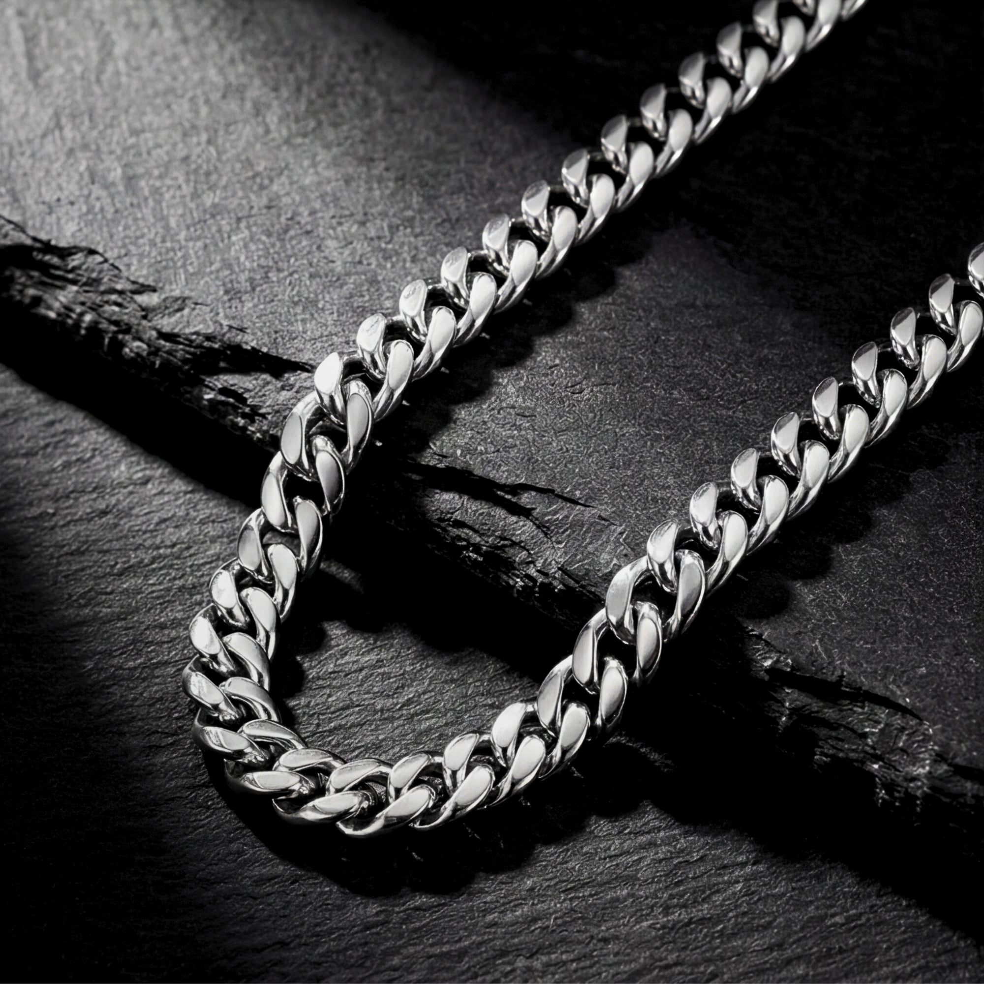 Angled close-up of the polished silver 8mm stainless steel Cuban link chain links.