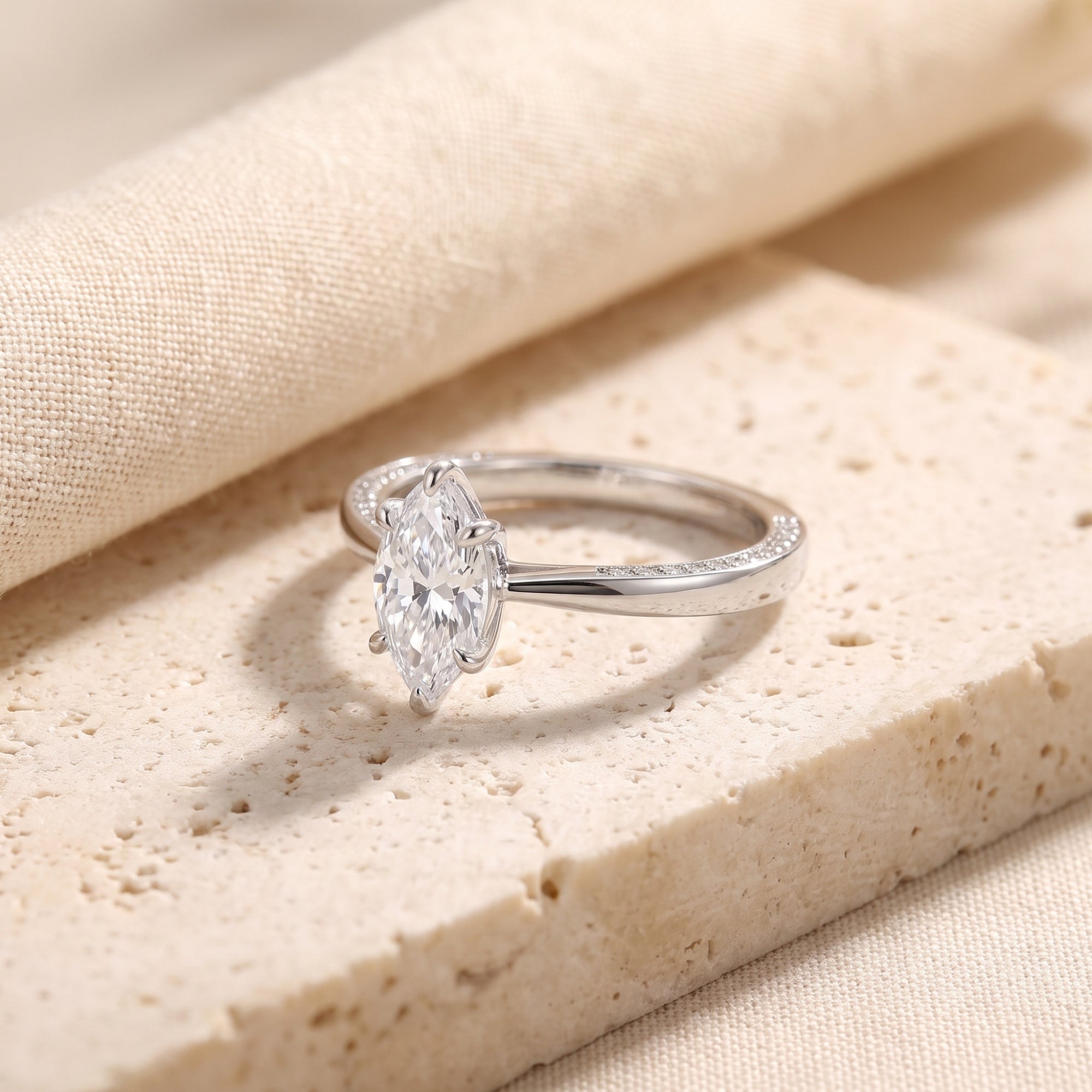 Side view of the Evanthea sterling silver ring highlighting the marquise-cut stone and pavé-set band.
