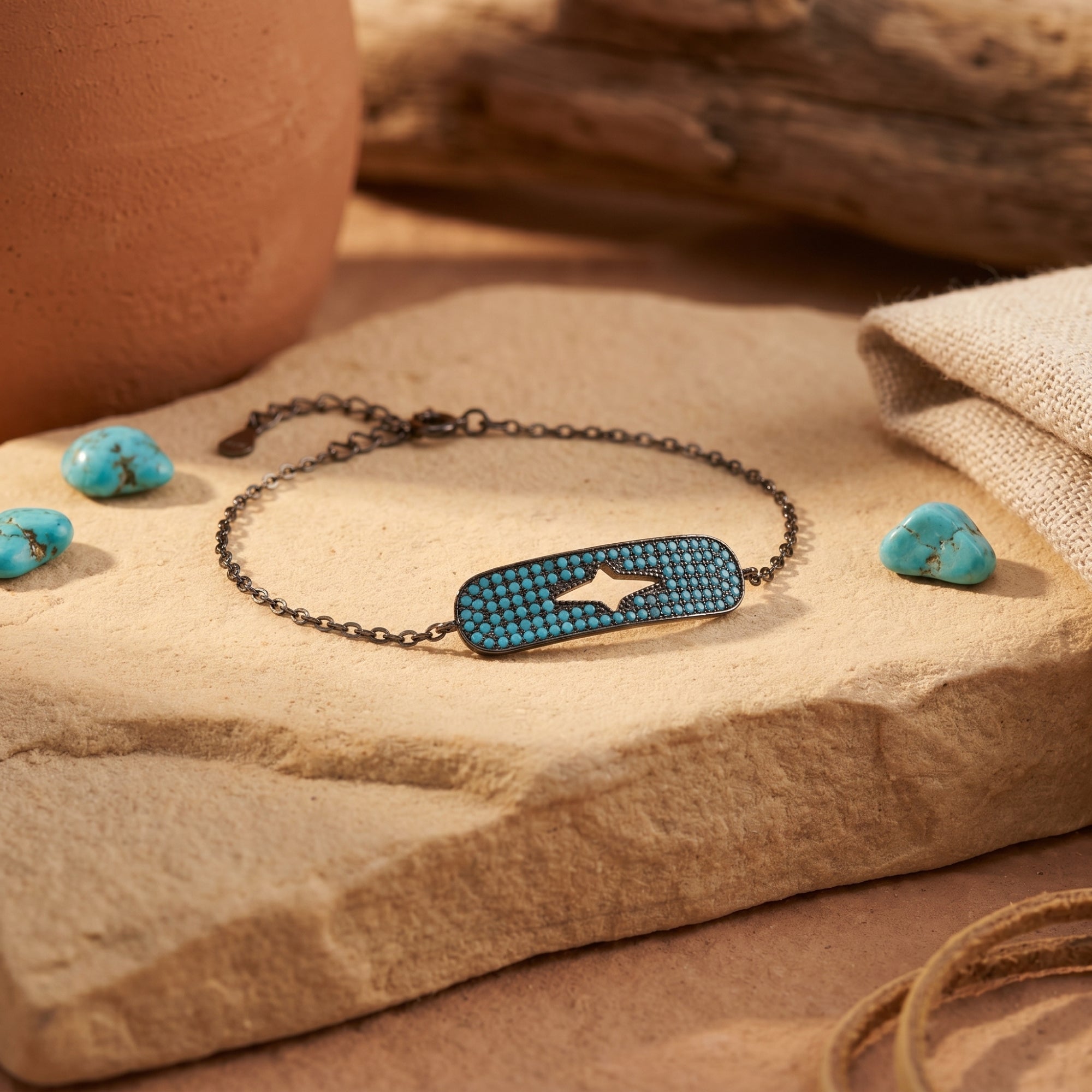 Close-up of the micro-set turquoise station and star cutout on the Estrella S925 sterling silver bracelet.