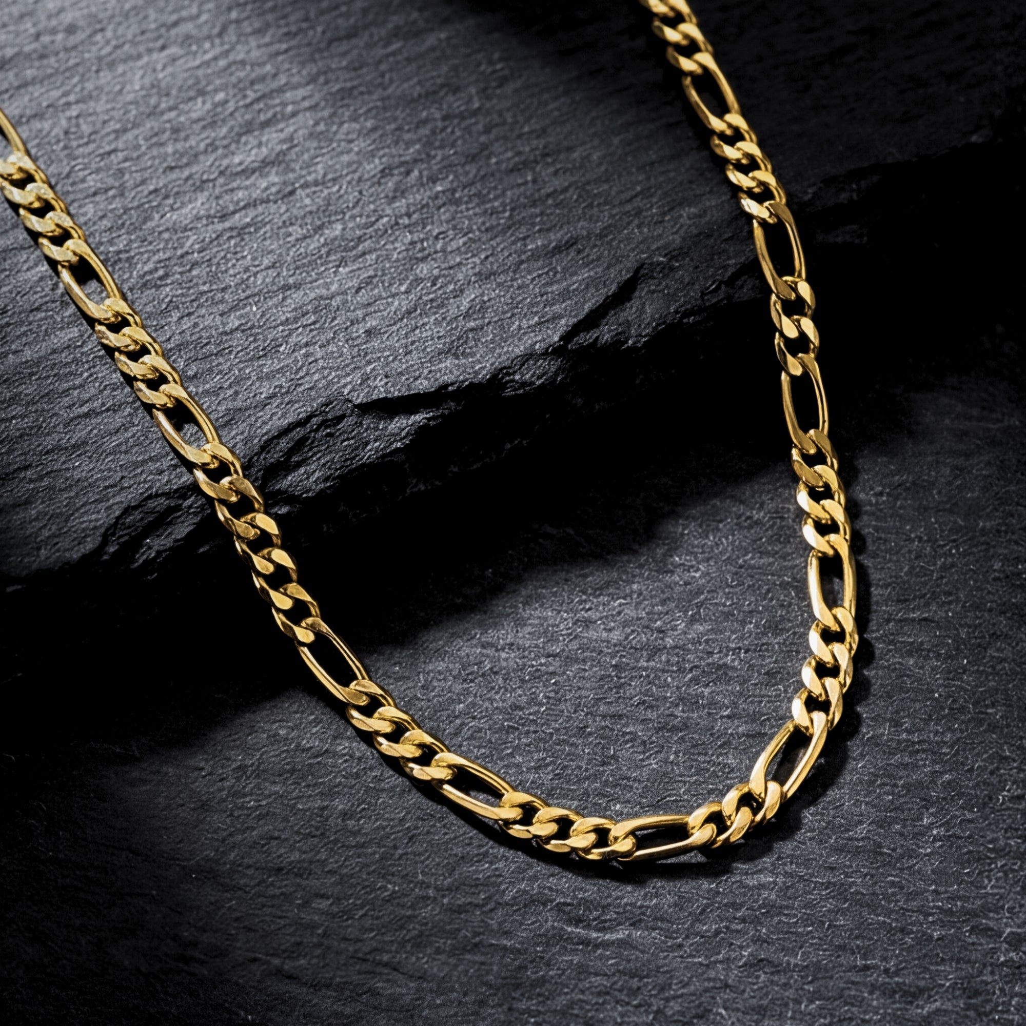 Macro shot of the gold ion-bonded stainless steel links on the Legacy Figaro chain.