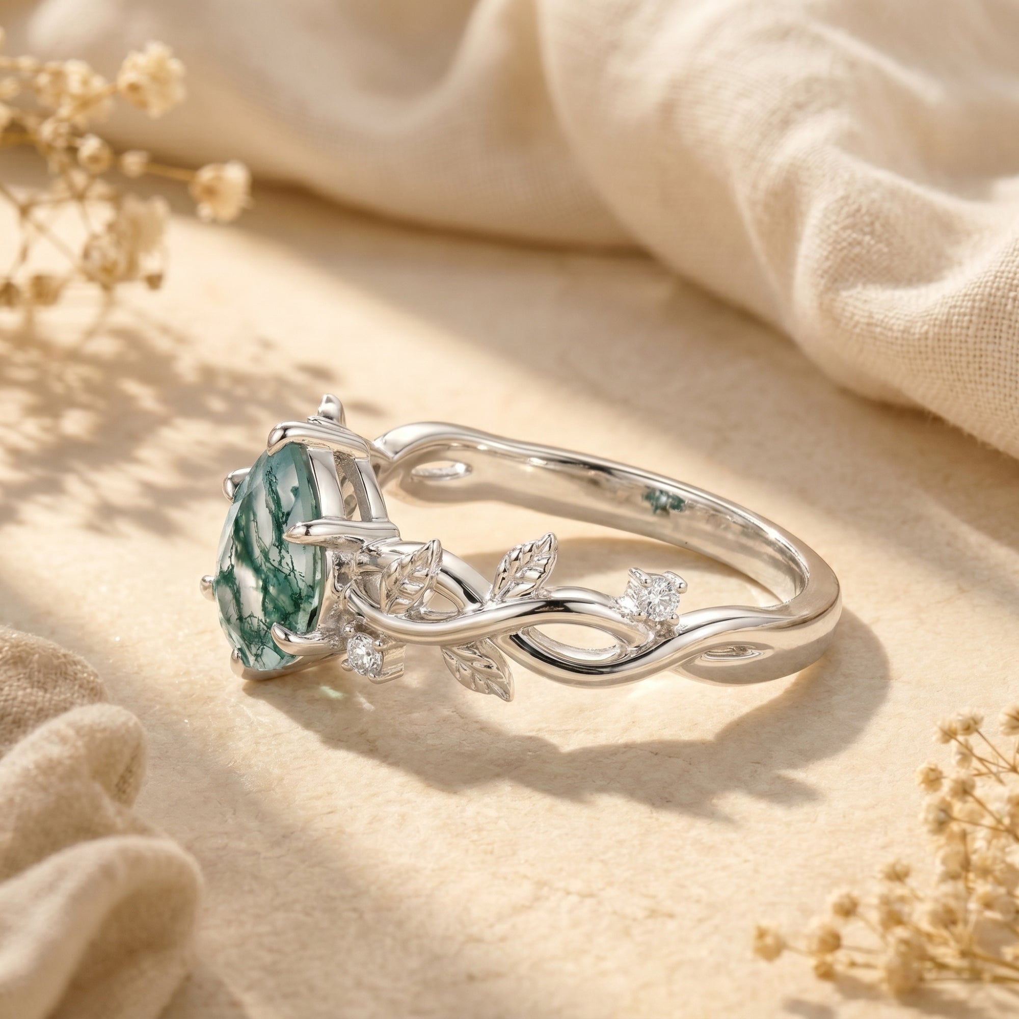 Side view of silver vine band and pear-cut moss agate stone setting.