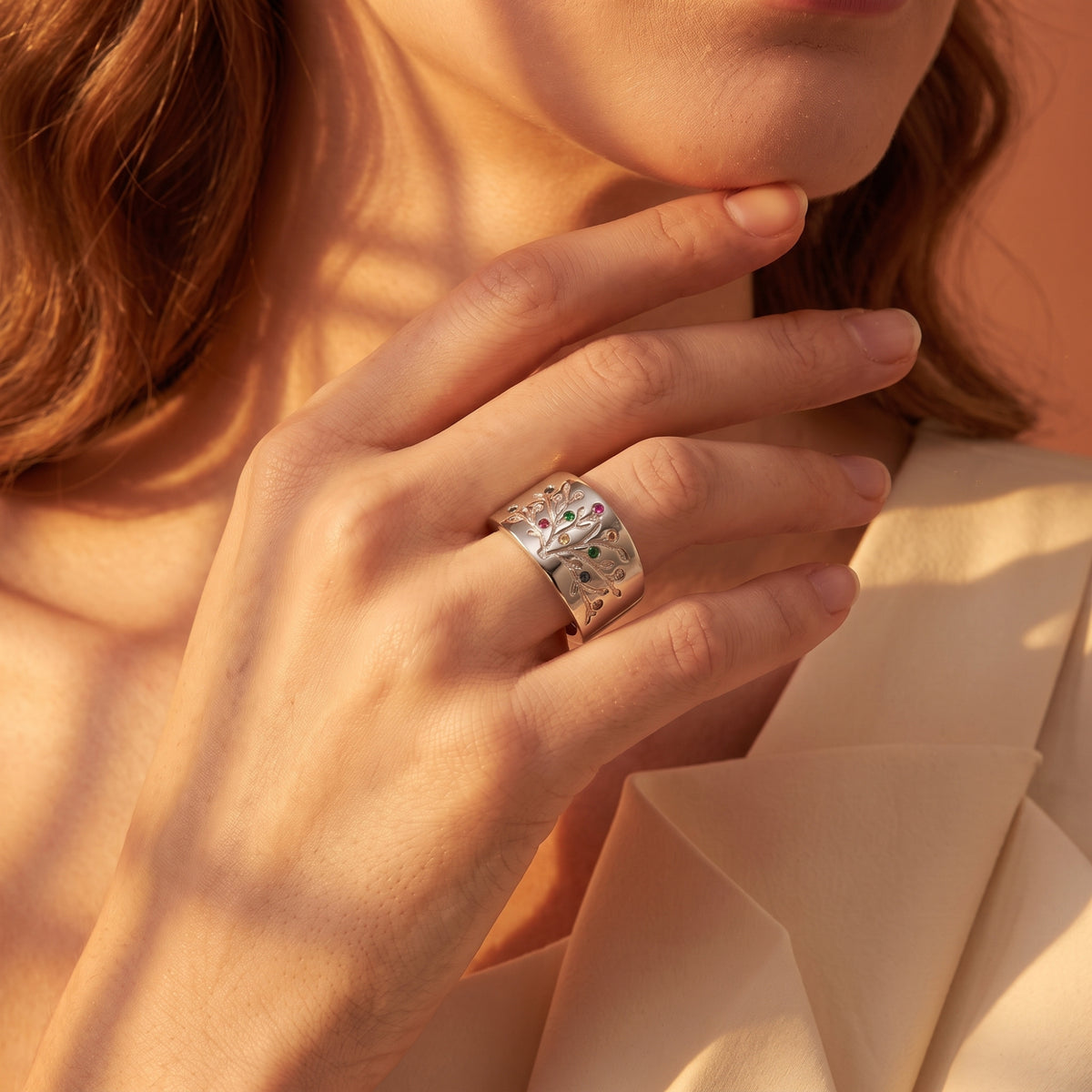 The Legacy Roots family tree ring in solid gold with simulated birthstones.