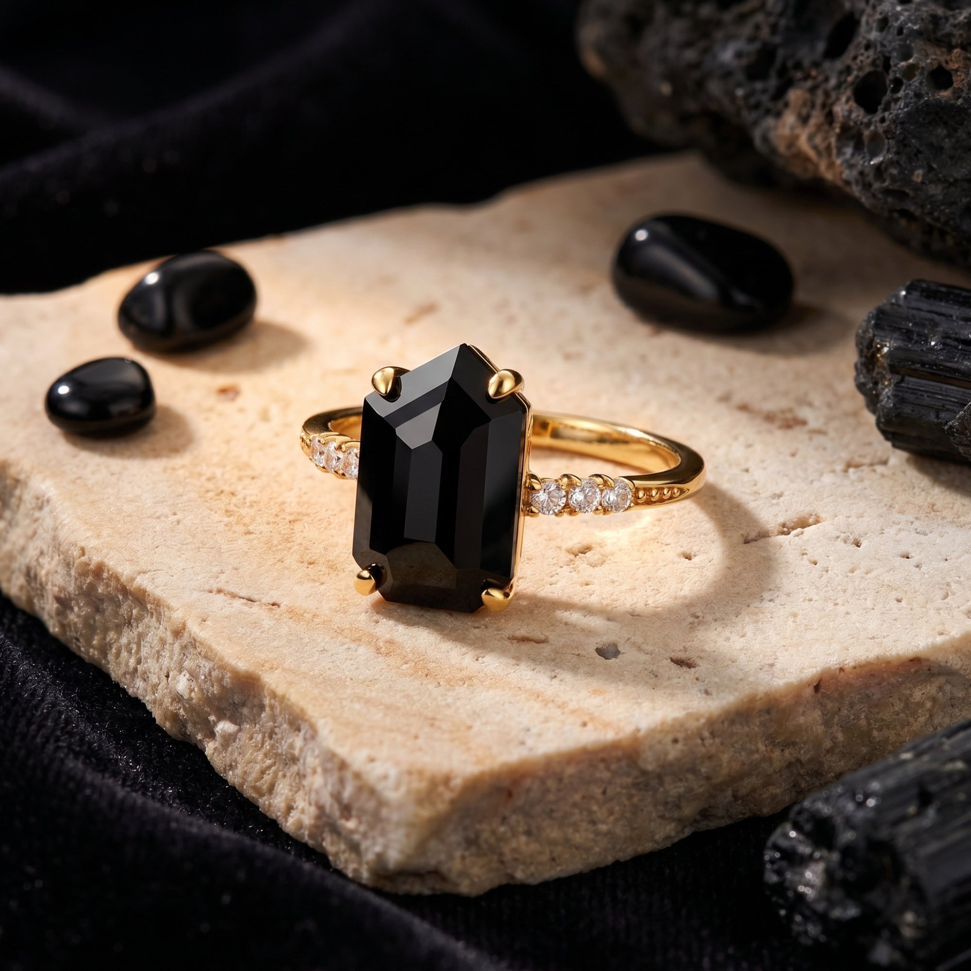 Macro view of the Noctura ring featuring an irregular-cut natural onyx stone and zircon-studded 18K gold band.
