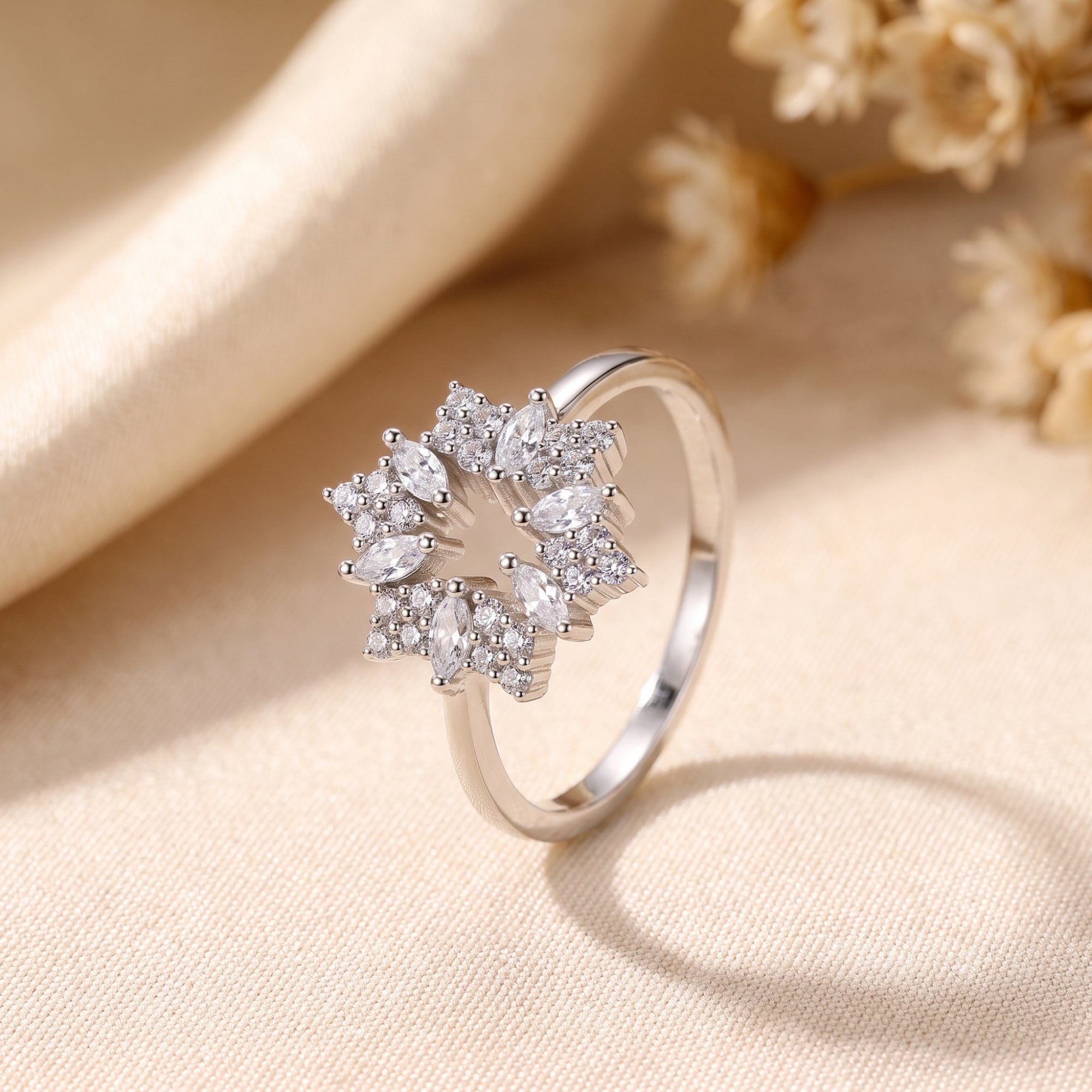 Close-up of the Stellaire S925 sterling silver ring's starburst setting with marquise and round stones.