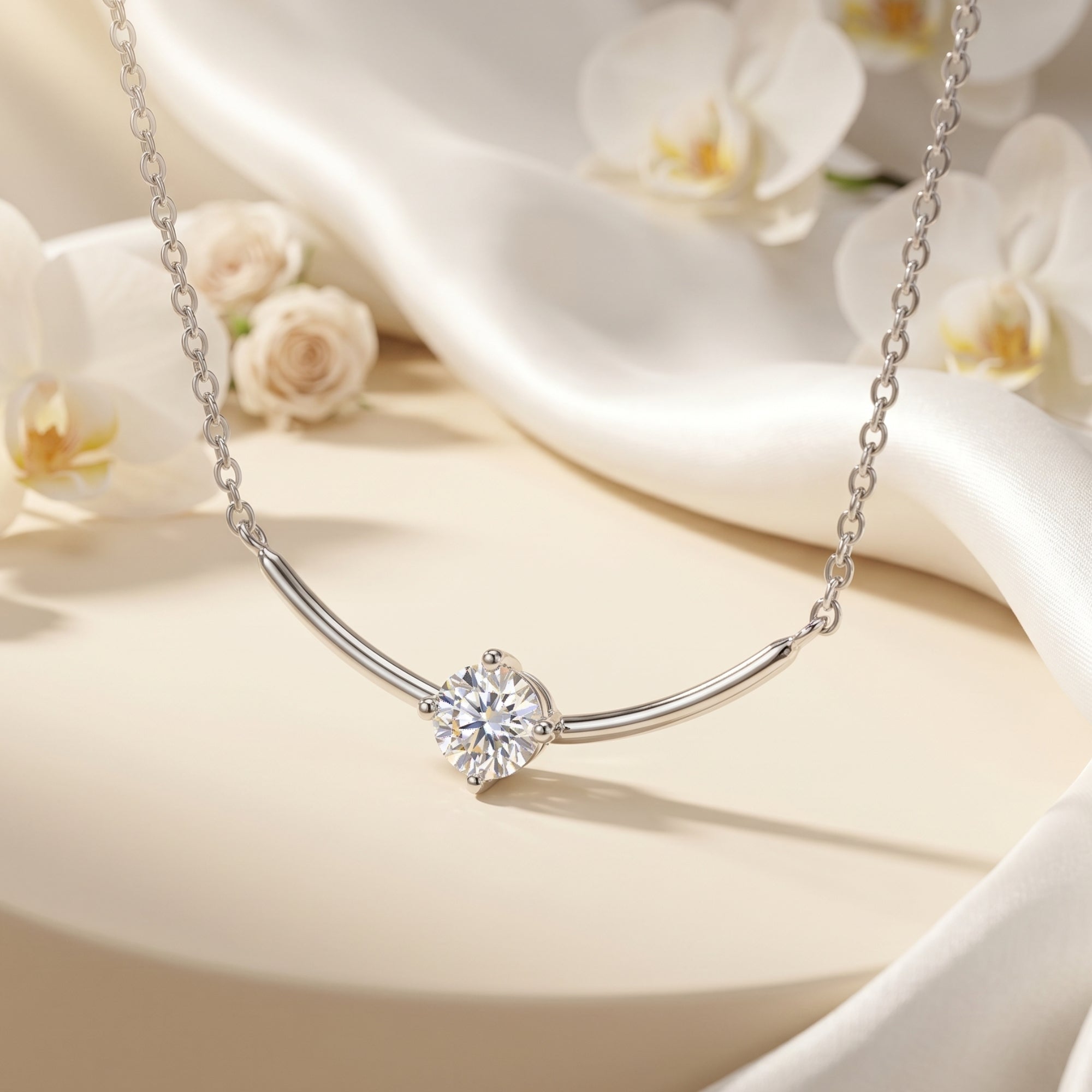Silver Elionara moissanite pendant necklace featuring a round cut stone on a curved bar, styled with flowers.