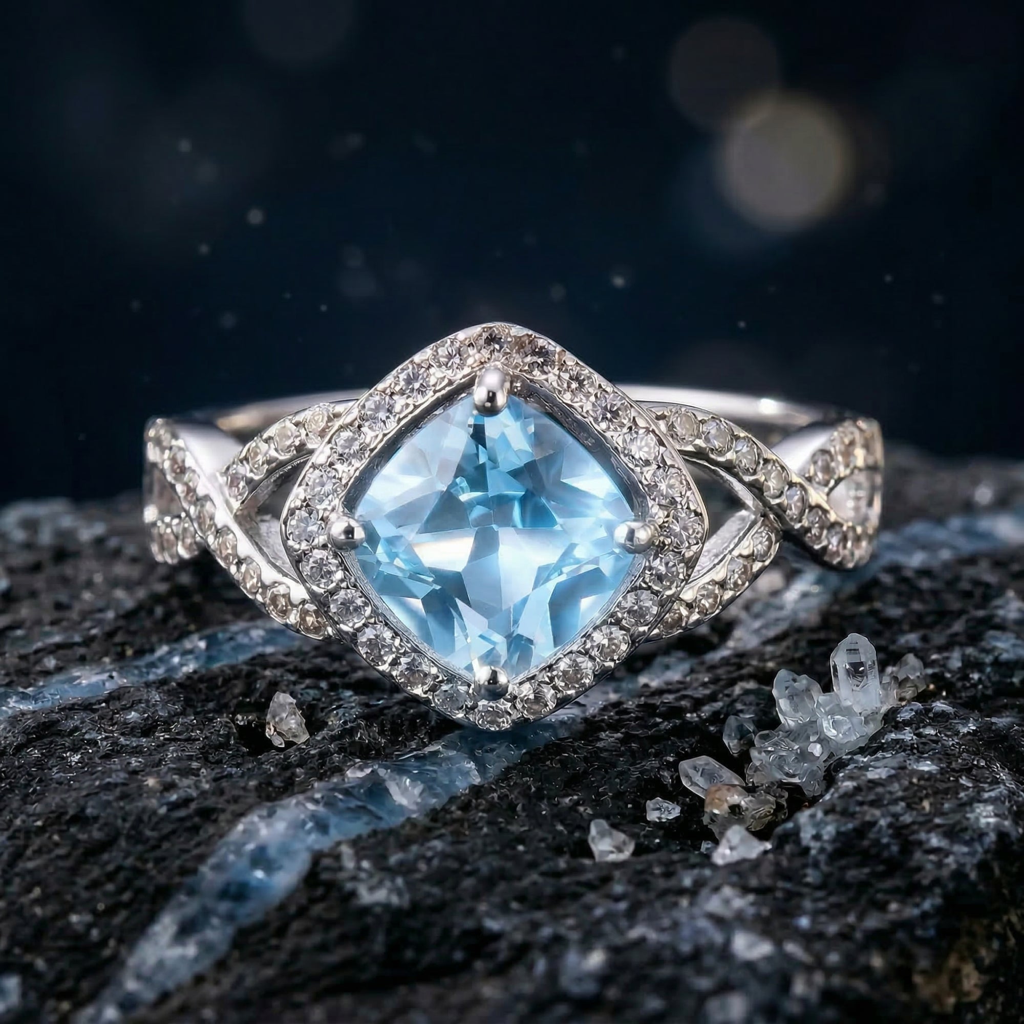 Macro shot of a cushion cut Swiss blue topaz ring in sterling silver showing the pave halo and stone facets.