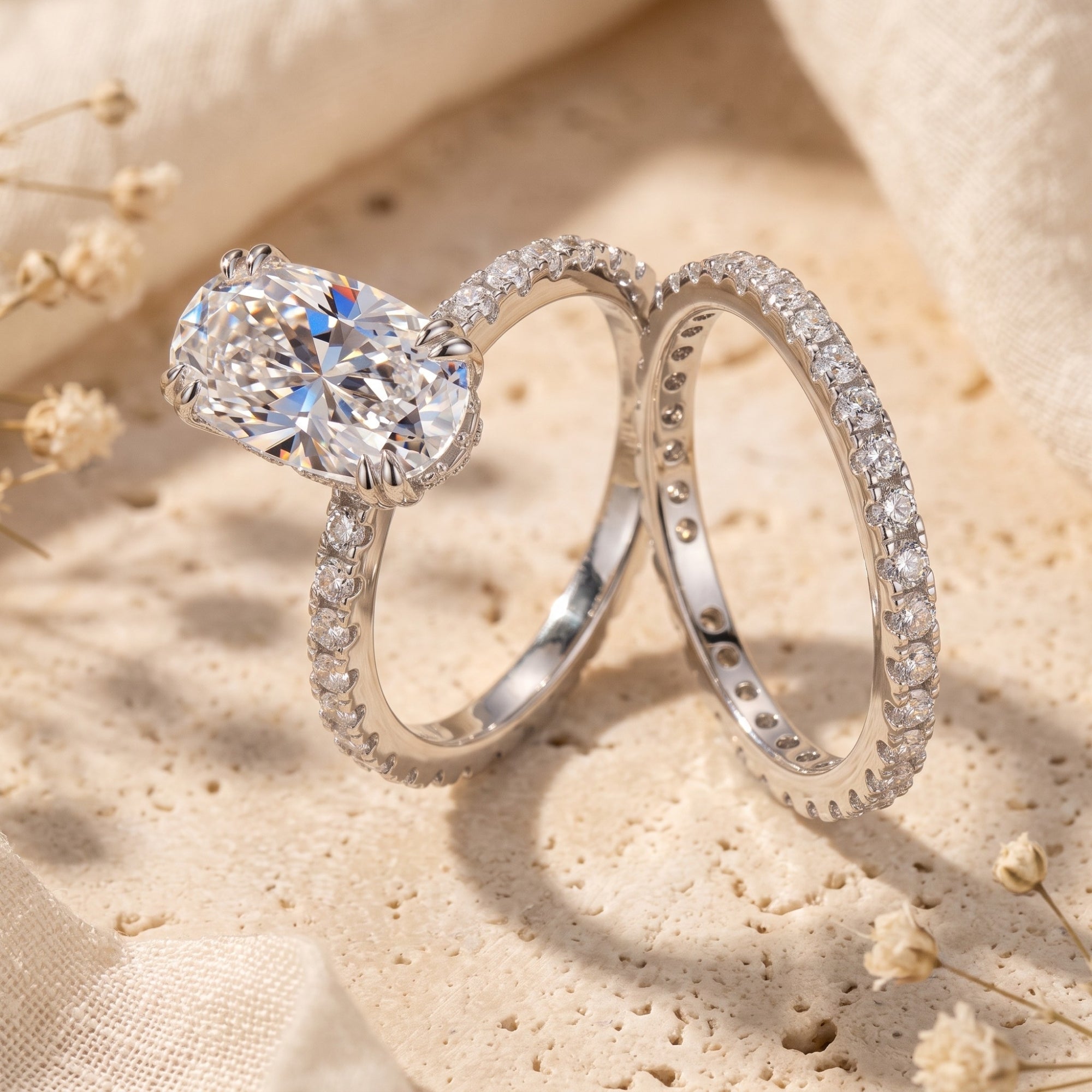 Side profile of the silver Elysinia oval-cut ring and matching band on stone.