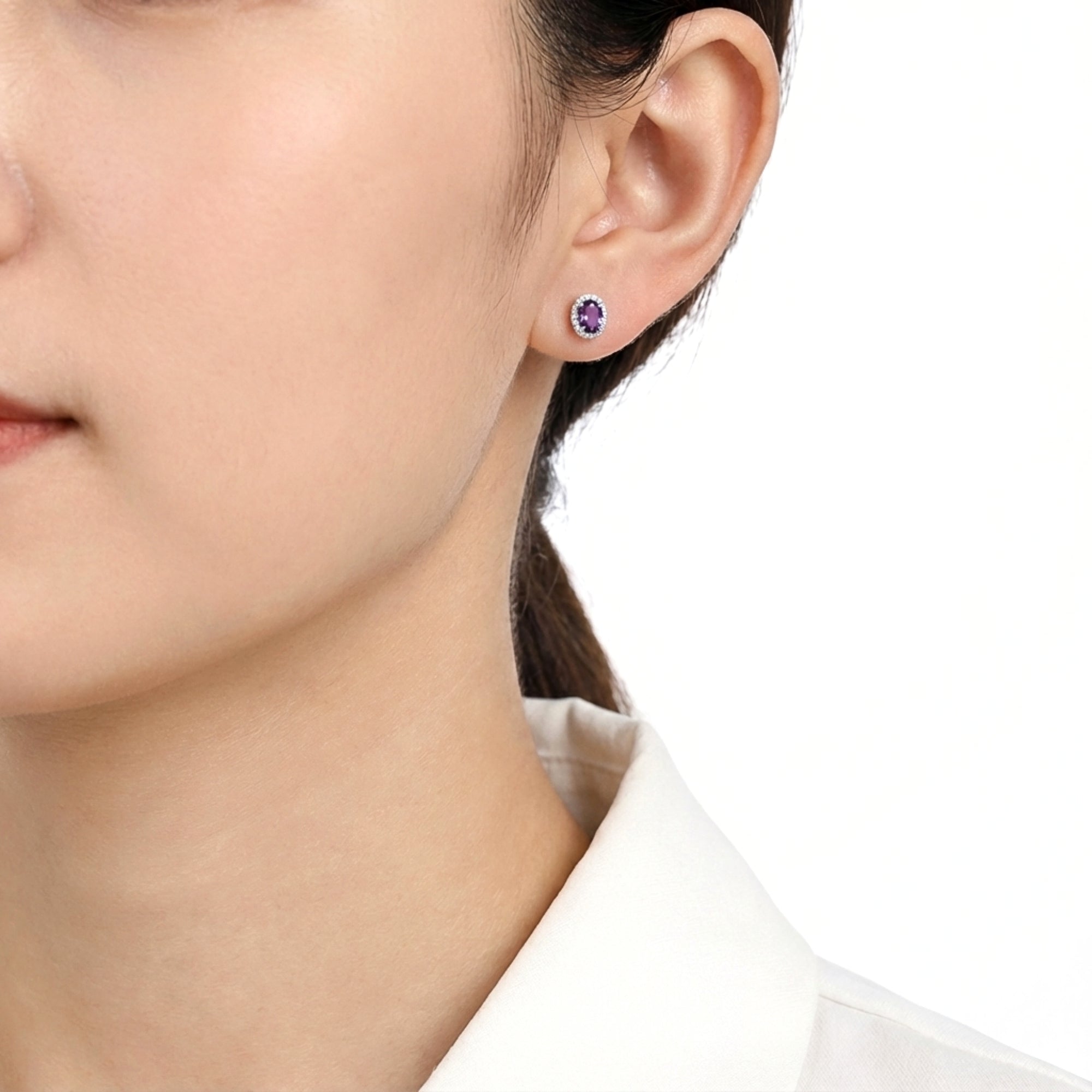 Model wearing a Celeste oval simulated amethyst halo stud earring in S925 sterling silver.