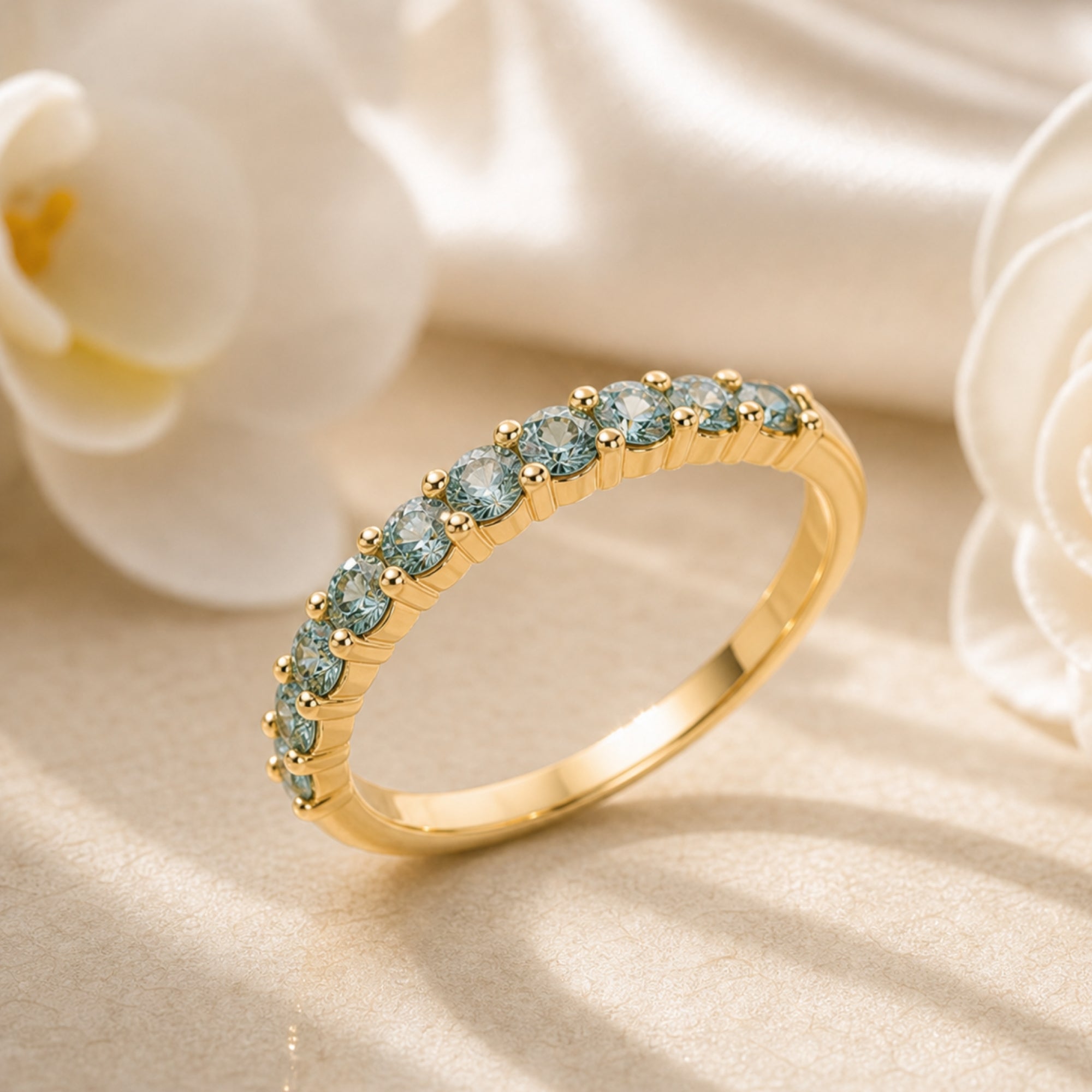 Yellow gold Fiorina ring with round simulated alexandrite stones in a floral lifestyle setting.