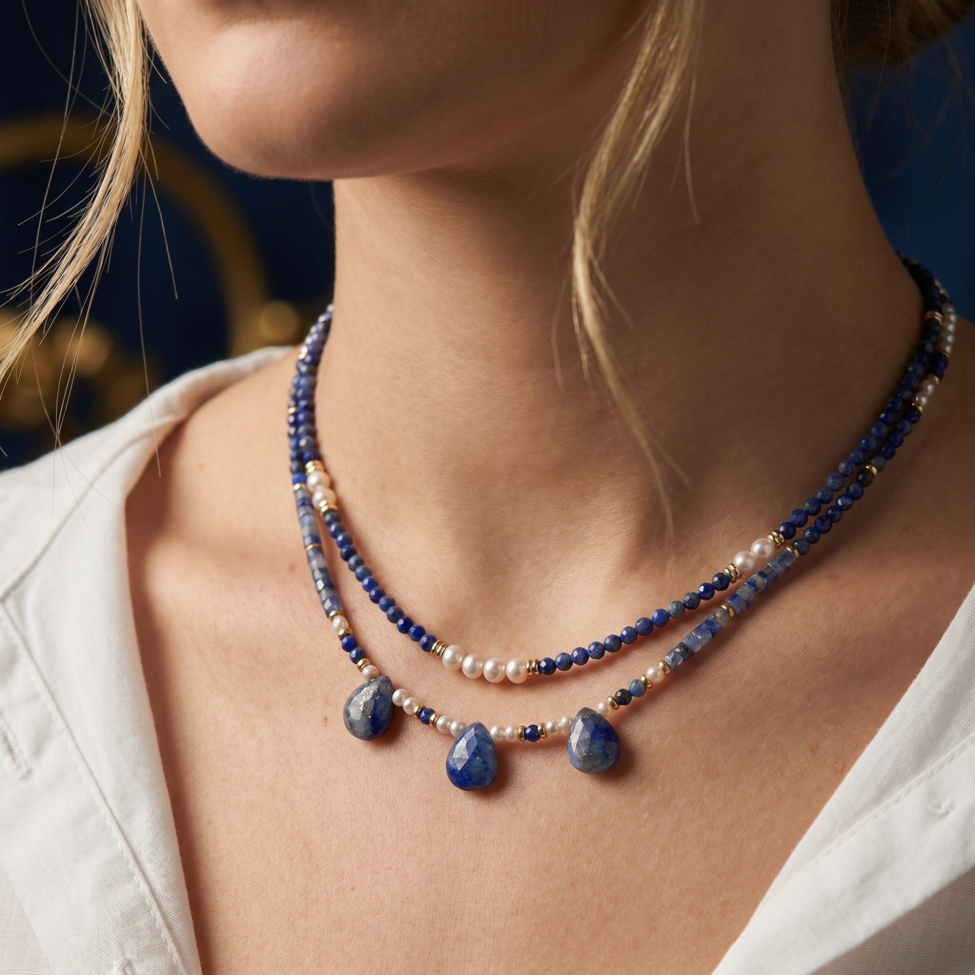Close-up of a model wearing the gold-plated layered necklace set with natural lapis lazuli and white pearls.