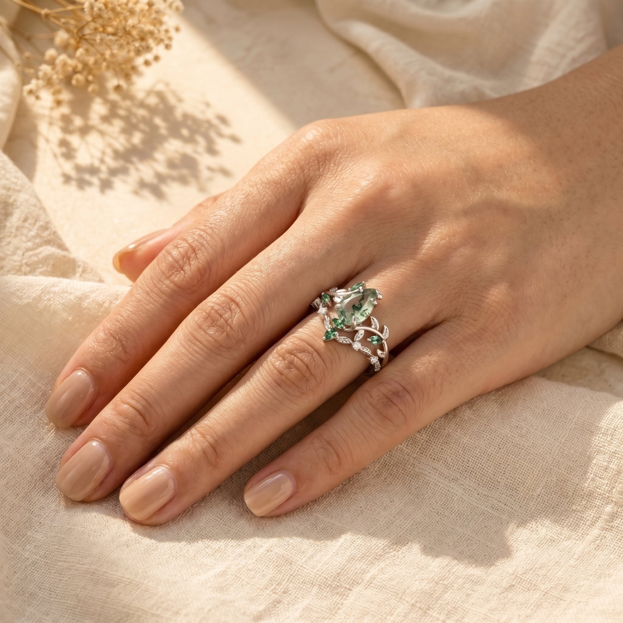 Hand wearing the silver moss agate vine ring set, showing the pear-cut stone and nature-inspired design.