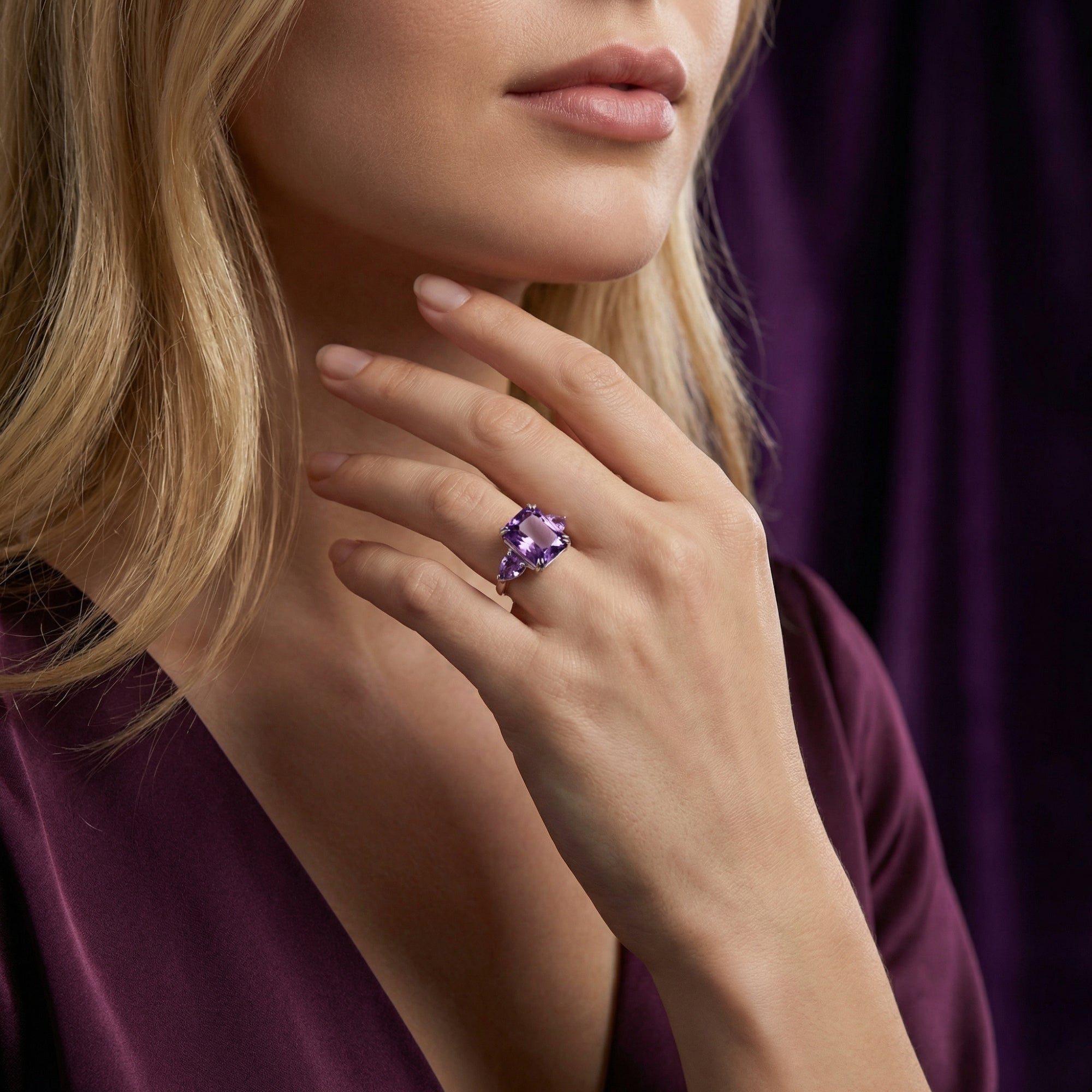 Model wearing the large square cut amethyst sterling silver ring on her finger, showcasing its regal size and color.