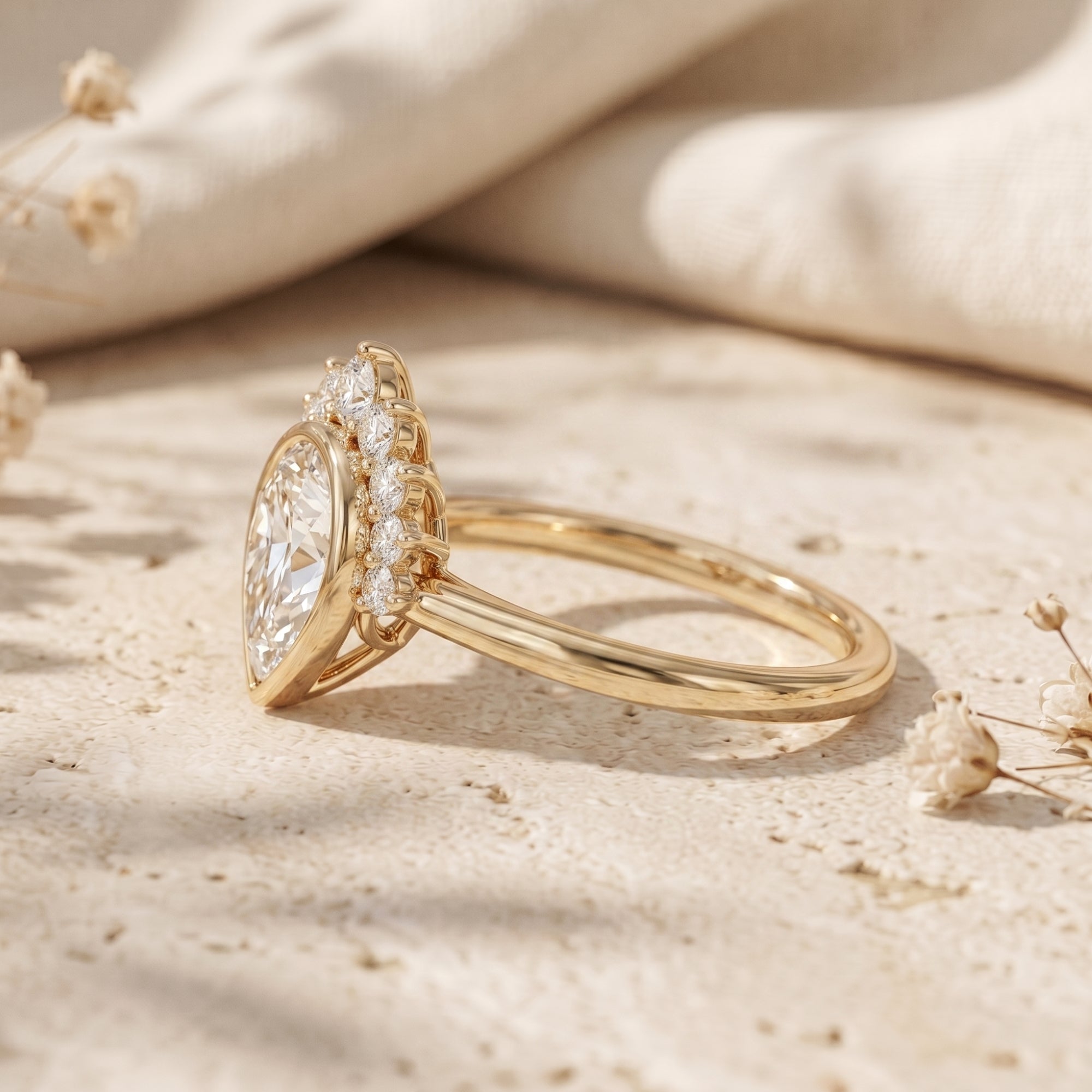 Side view of a gold pear-cut moissanite ring showing the crown setting and band.
