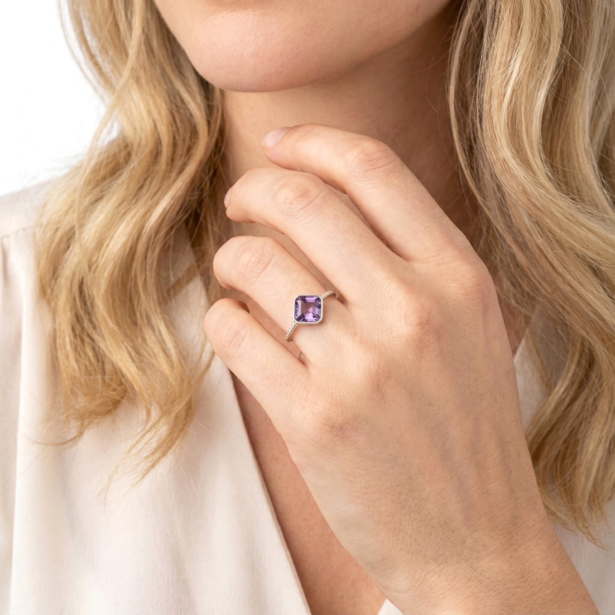 Model wearing the Verity S925 sterling silver ring with a deep violet cushion-cut simulated amethyst.