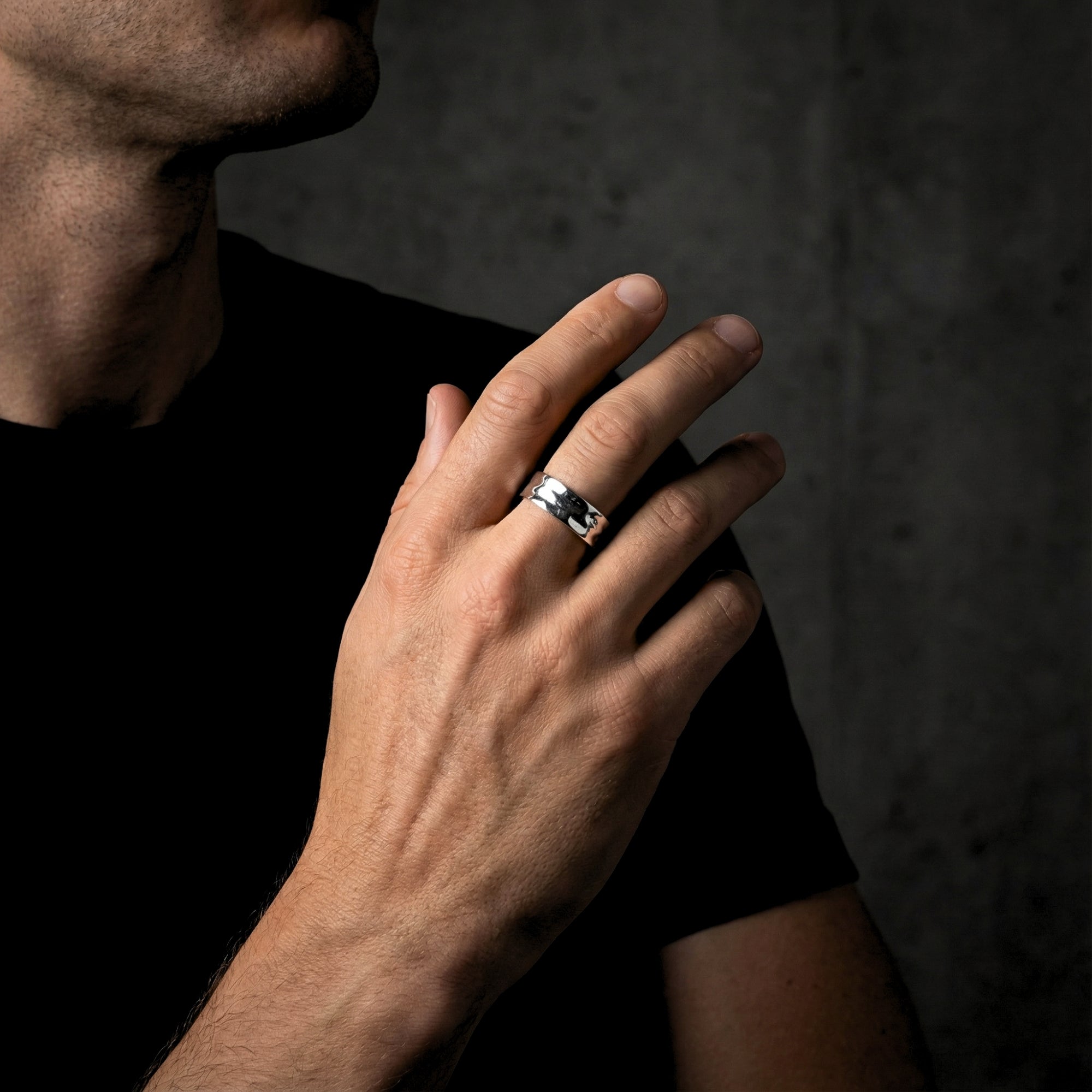 Man wearing the silver stainless steel Origin Flex adjustable ring, showing the band's width and fit.