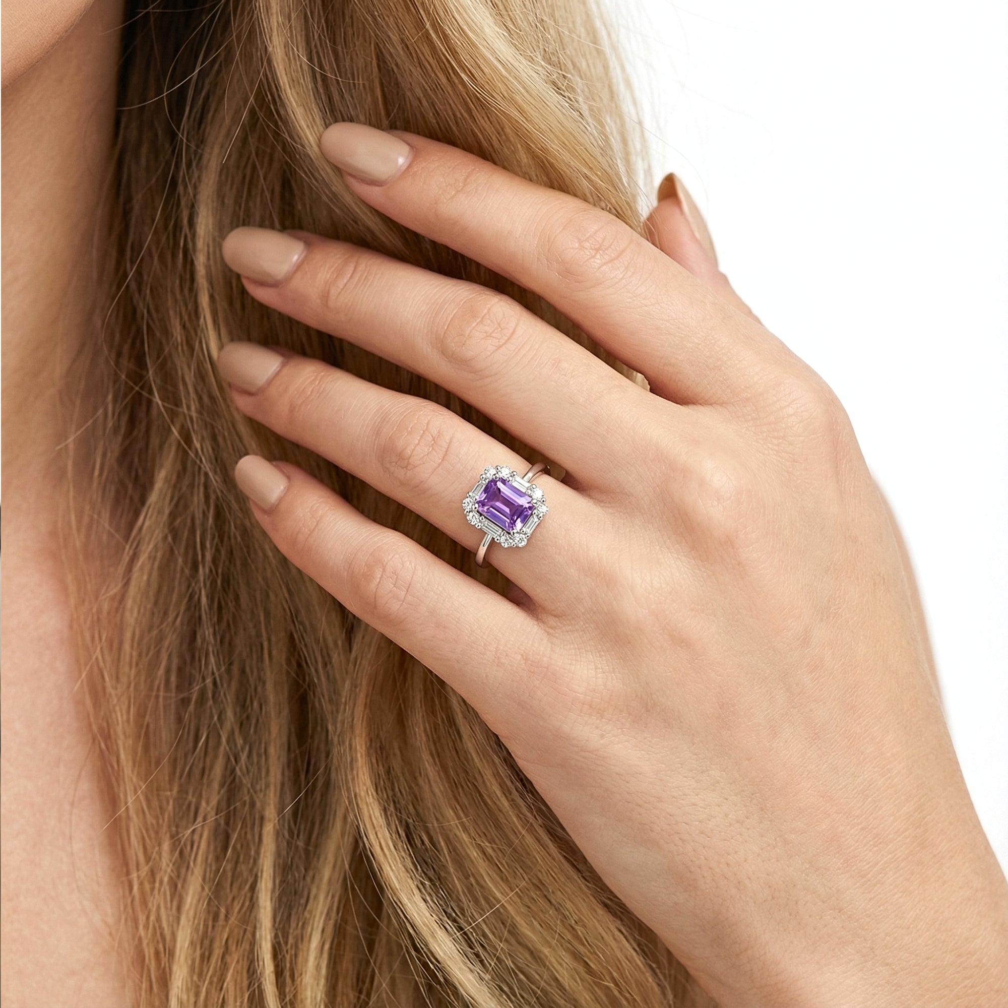 Close-up of the S925 sterling silver emerald cut amethyst halo ring worn on a model's hand.