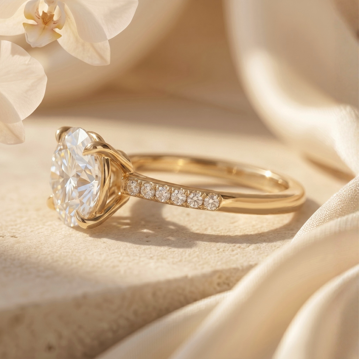 A side angle view of a round-cut moissanite engagement ring featuring a yellow gold band.