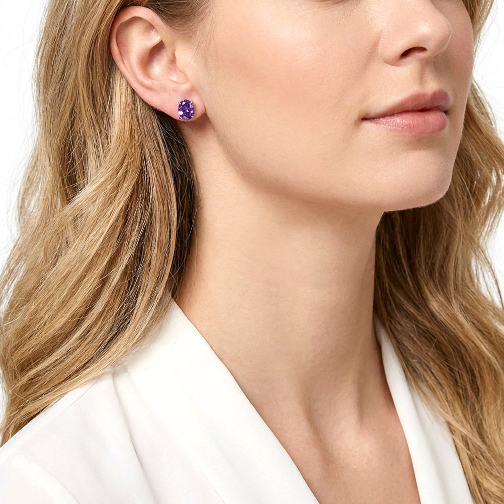 Model wearing the Calliope oval cut purple simulated amethyst stud earrings in sterling silver.
