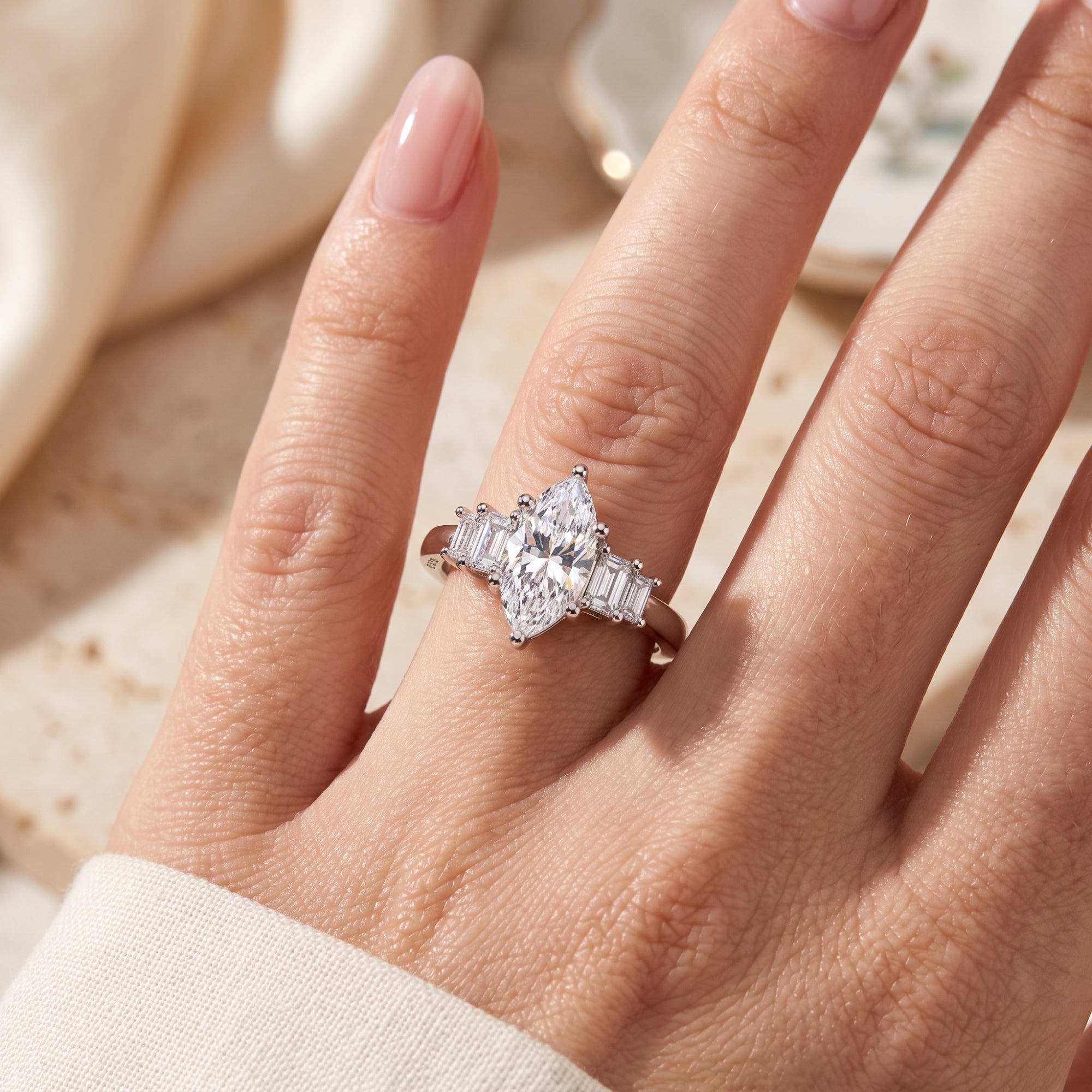 Top-down view of the silver Melanthe ring with marquise stone on a hand.