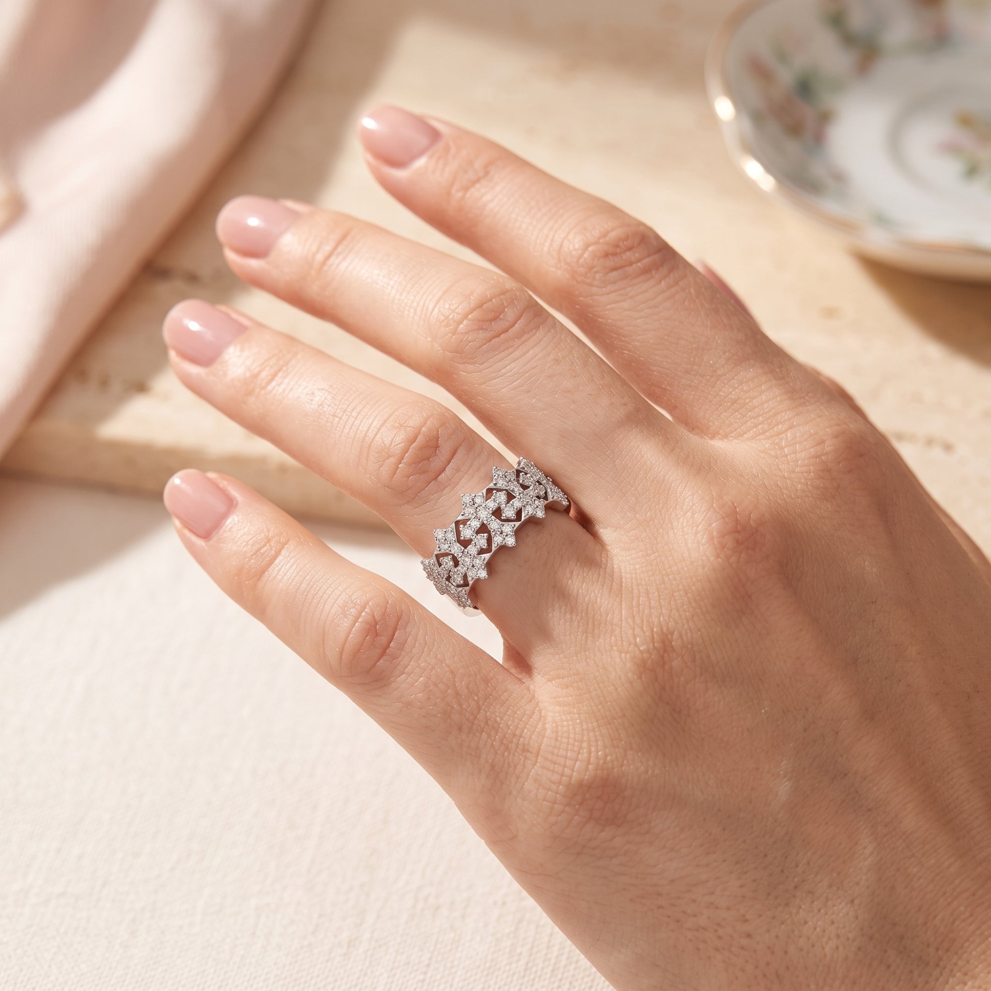 Sterling silver snowflake crown ring with simulated diamonds worn in a lifestyle setting.