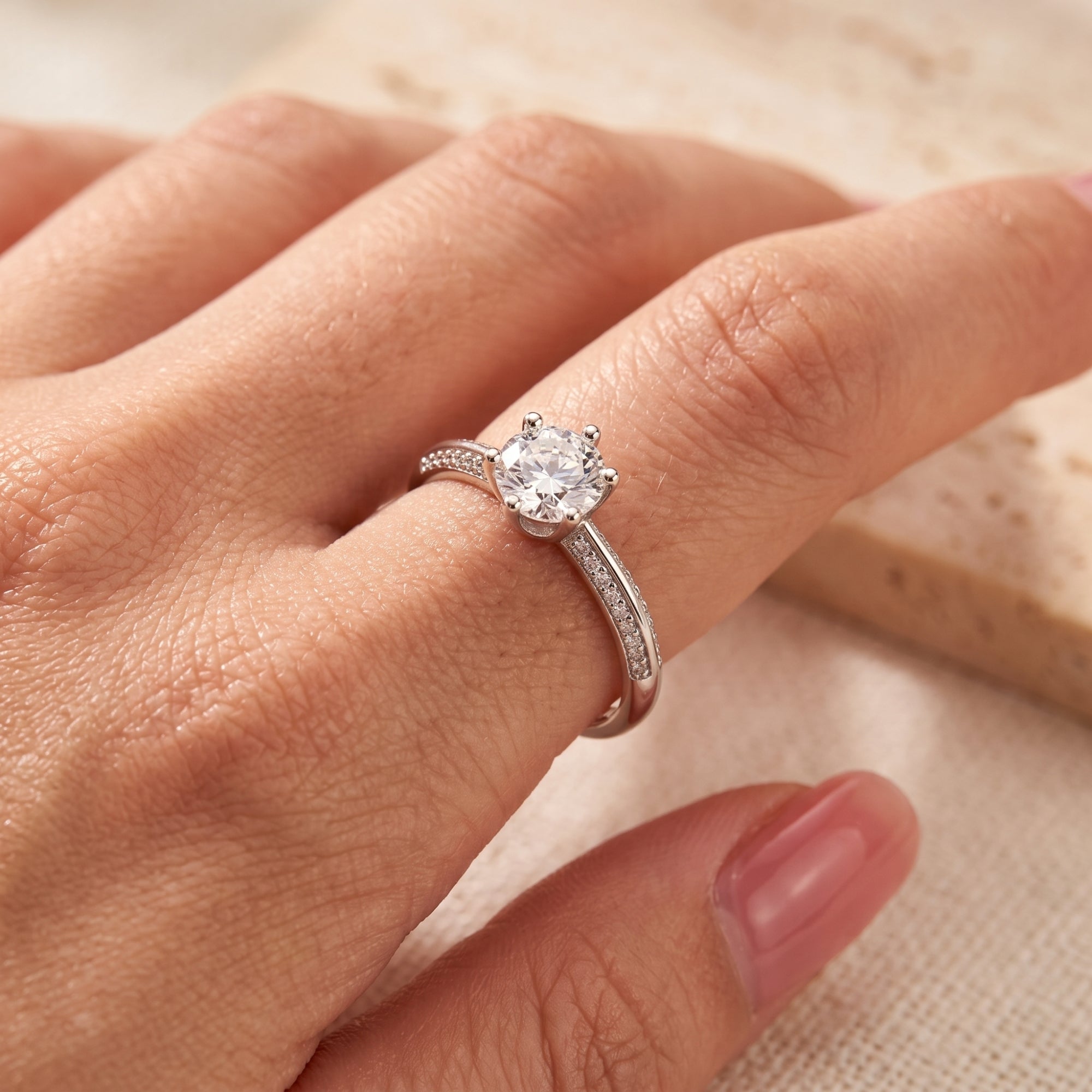Close-up of the Cassidienne silver ring with a round brilliant stone worn on a finger.