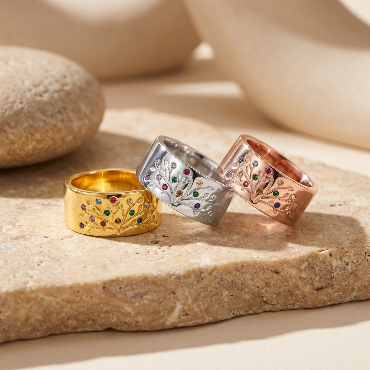 Solid gold ring with a detailed family tree design and simulated birthstones.