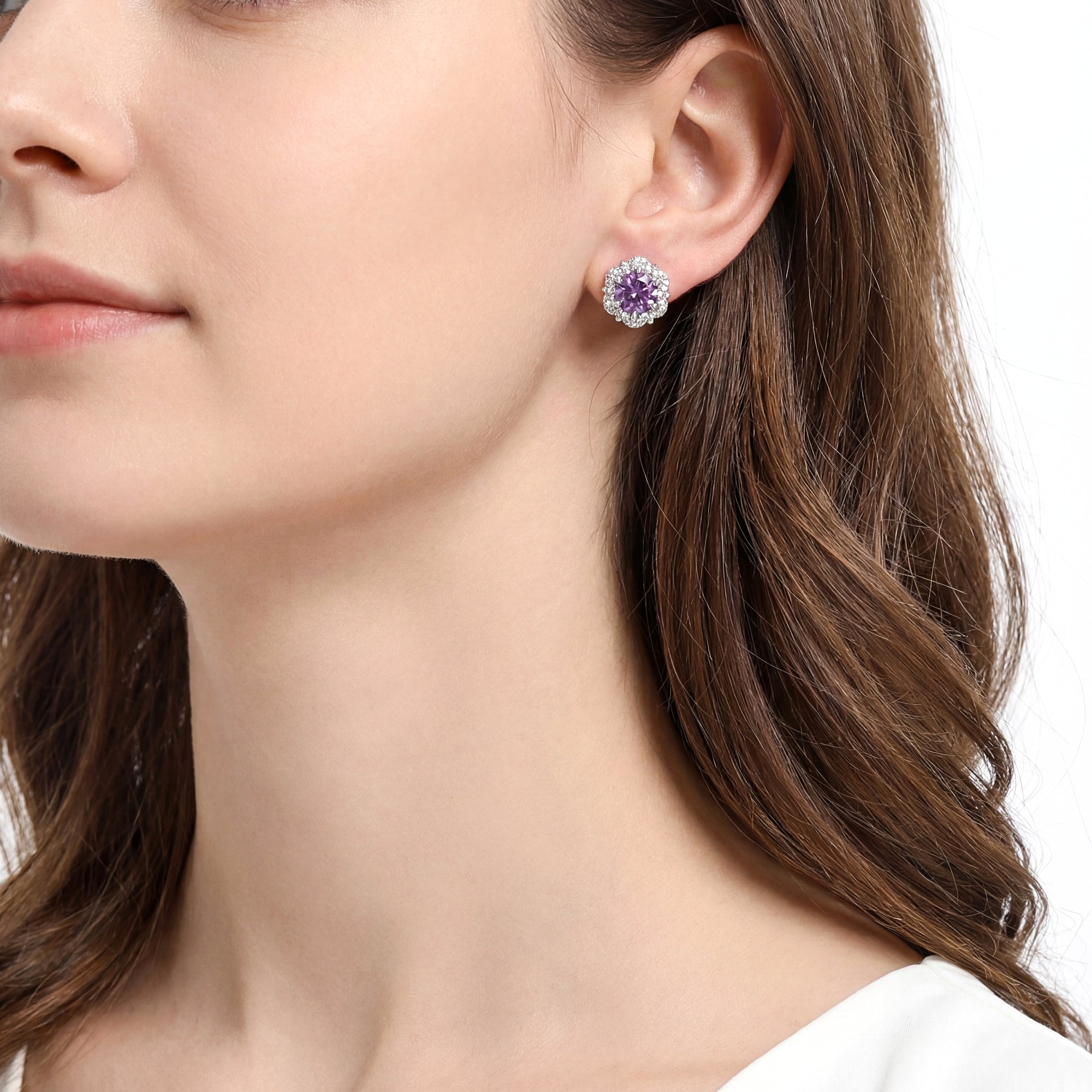 Side view of a woman wearing a round cut simulated amethyst floral halo stud earring in S925 sterling silver.