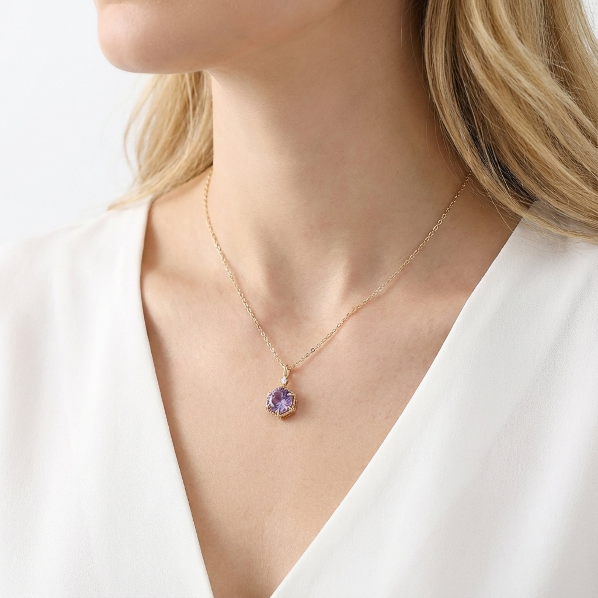 Side profile of a model wearing the gold vermeil February birthstone necklace with a purple amethyst pendant.