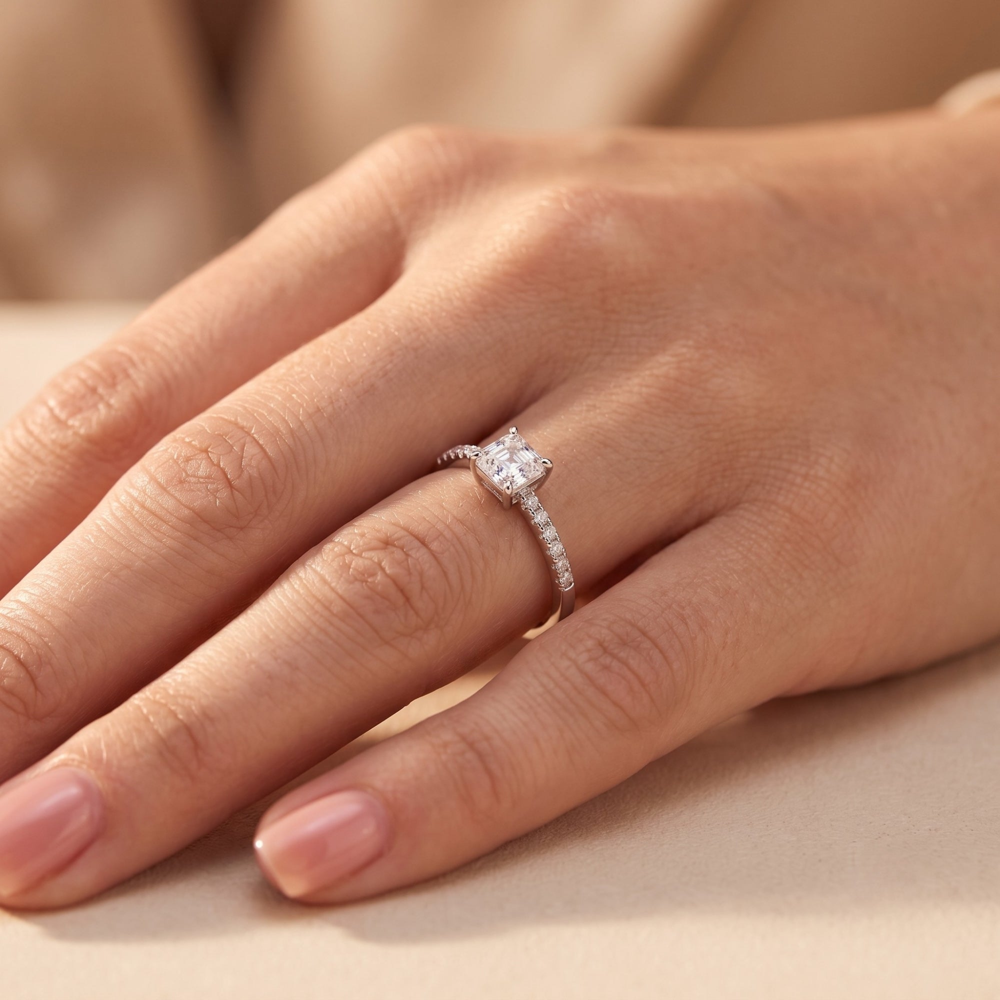 Princess cut CZ sterling silver ring on a model's hand.