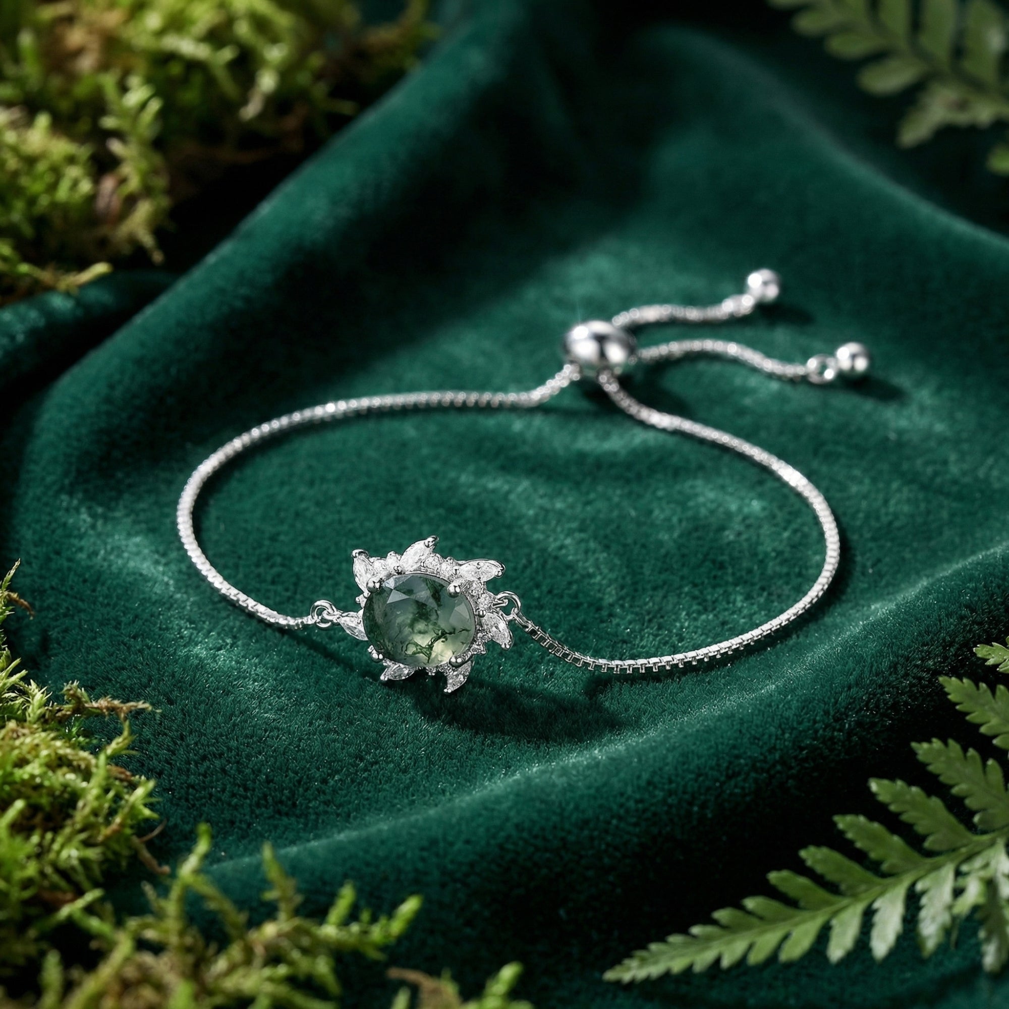 Detailed view of the adjustable sterling silver bracelet featuring a round Moss Agate stone with a floral halo.