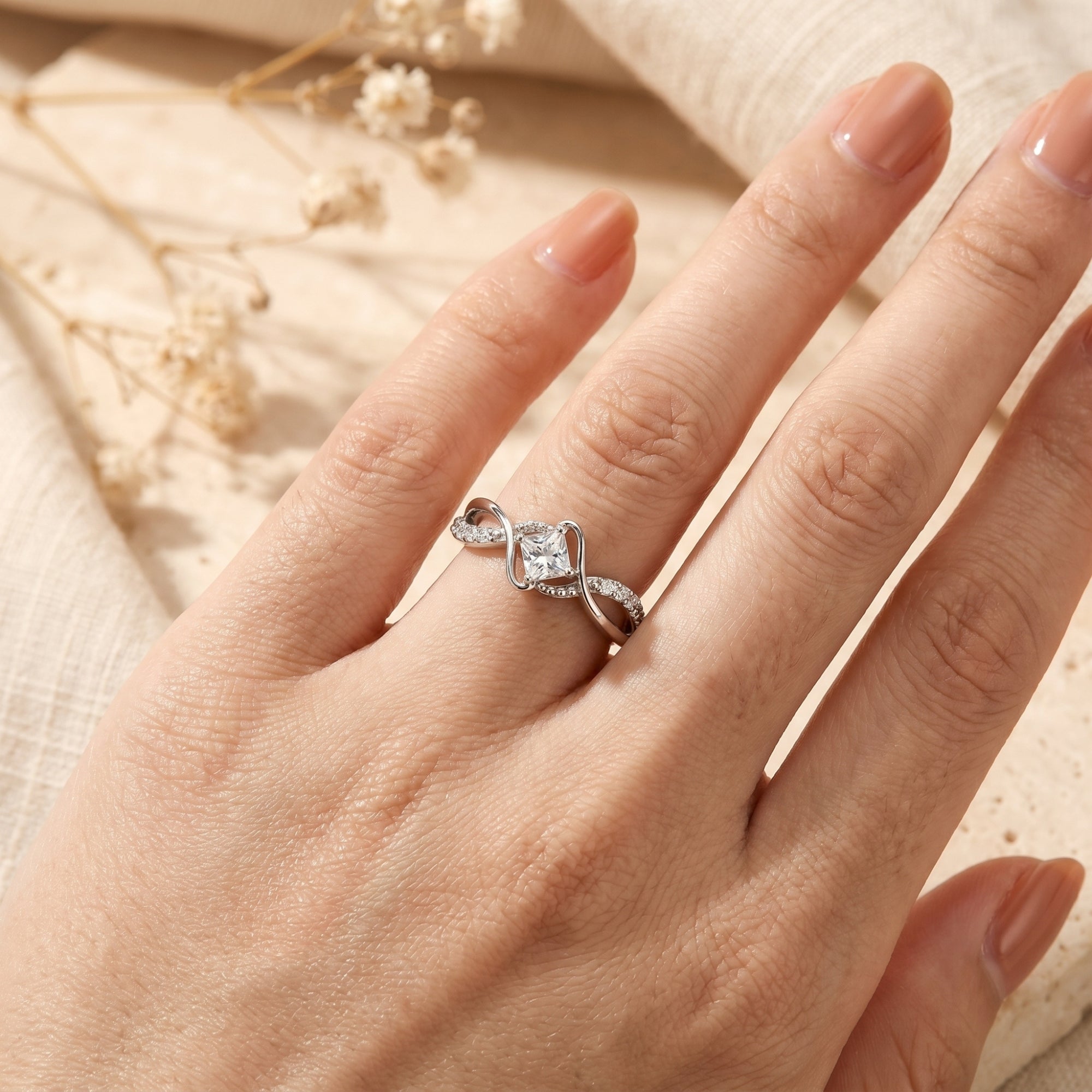 Elorise princess cut moissanite ring in S925 sterling silver worn on a finger.